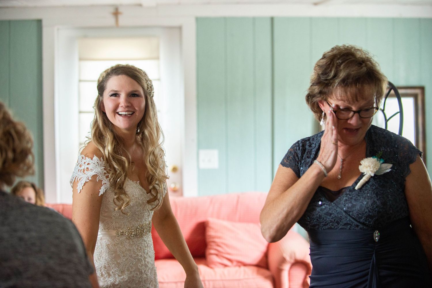 Wedding couple shares intimate moments in a light-filled room with mint green walls. Rum River Barn Milaca Minnesota Weddings