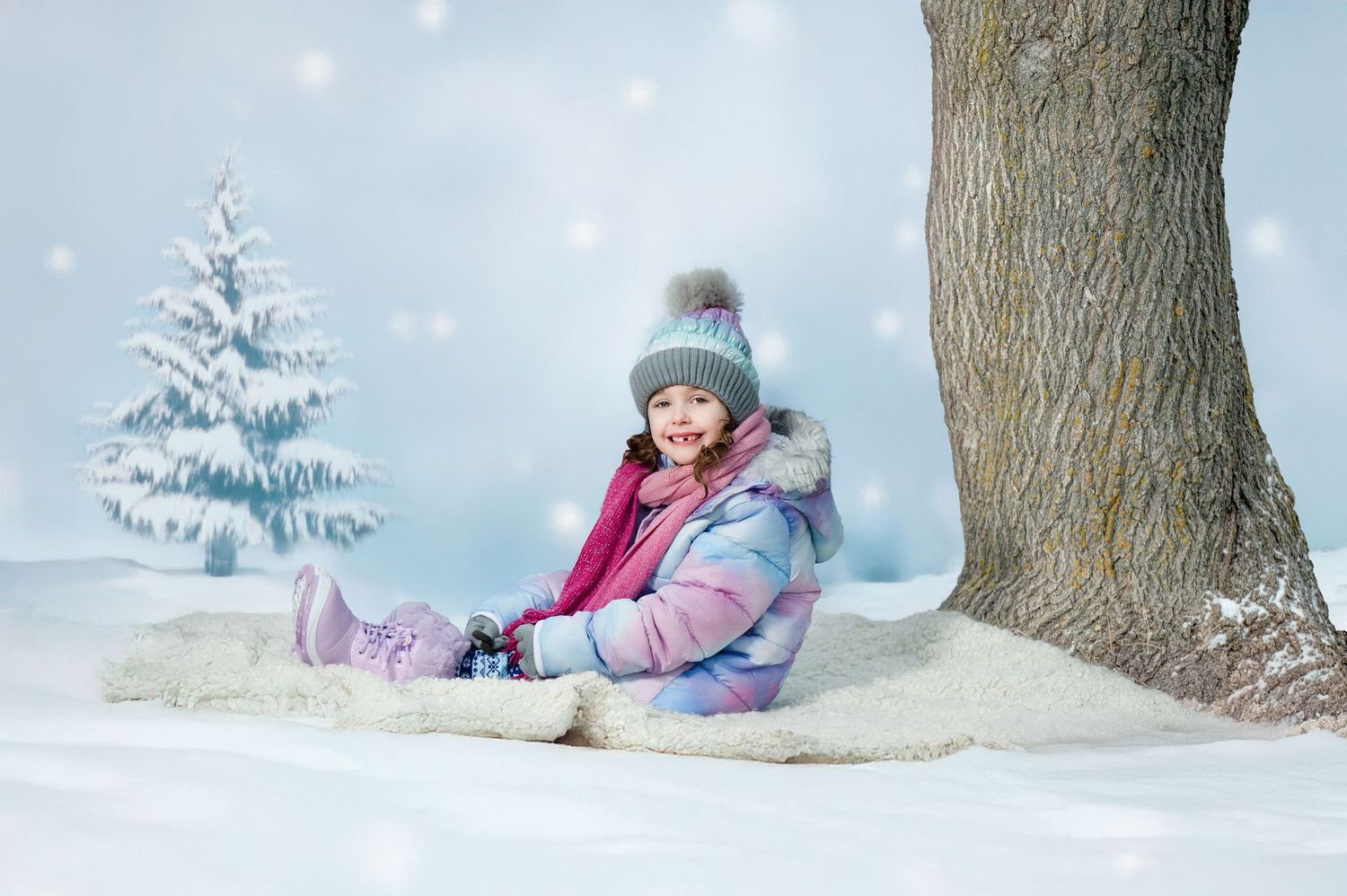 Snowy winter scene with someone playing in fresh powder snow near a tree in winter clothing.