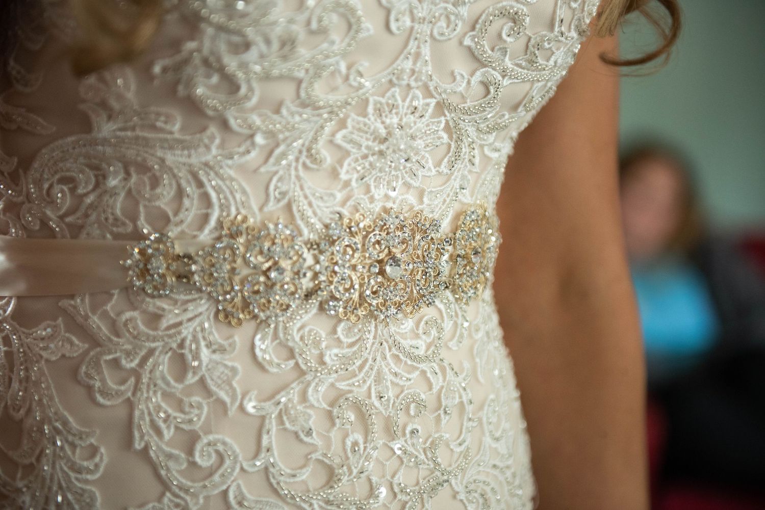 Detailed close-up shots of an ornate lace wedding dress pattern with delicate swirls and beading. Rum River Barn Milaca Minnesota Weddings