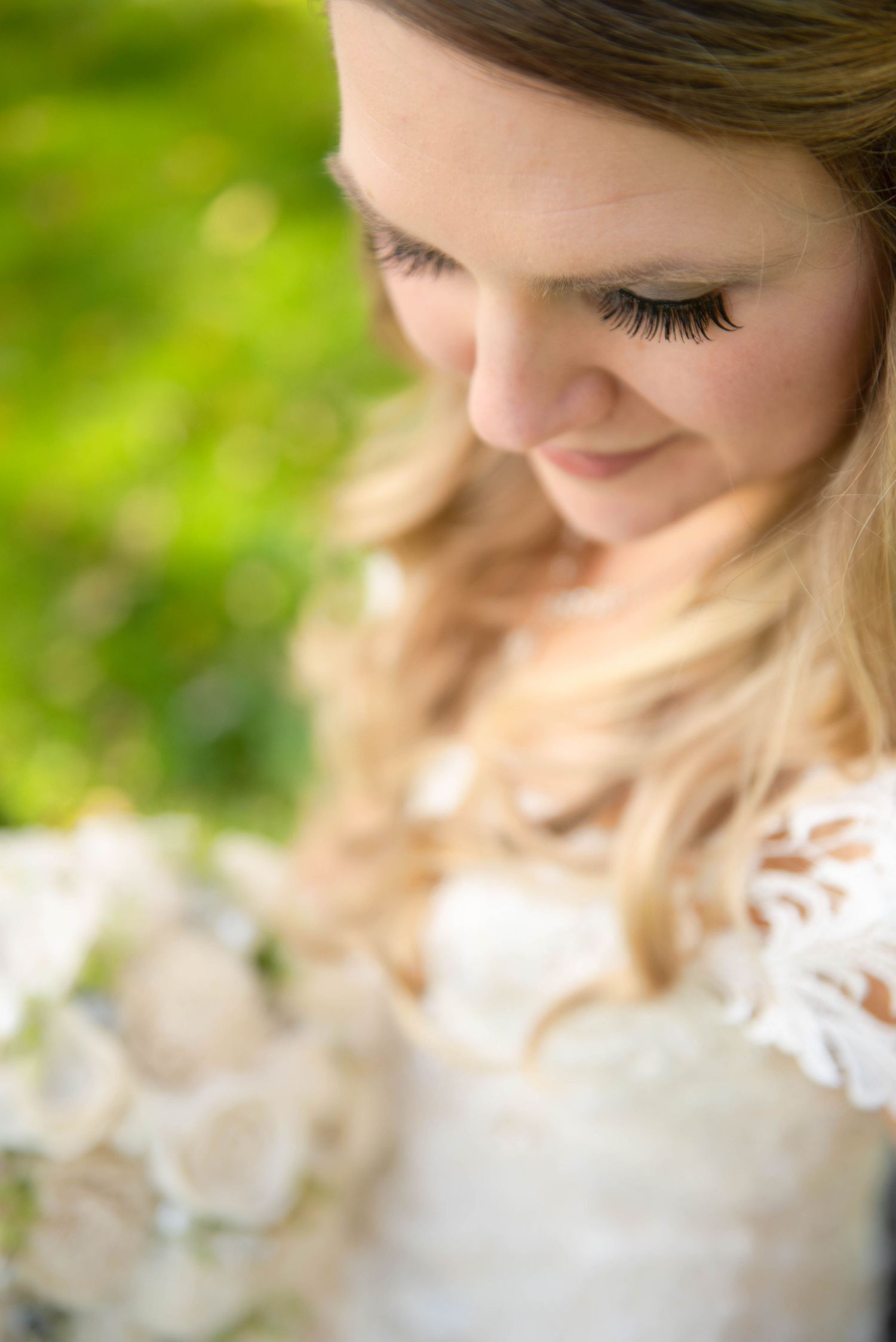 Close-up detail of delicate lace and soft lighting in a romantic bridal portrait. Rum River Barn Milaca Minnesota Weddings