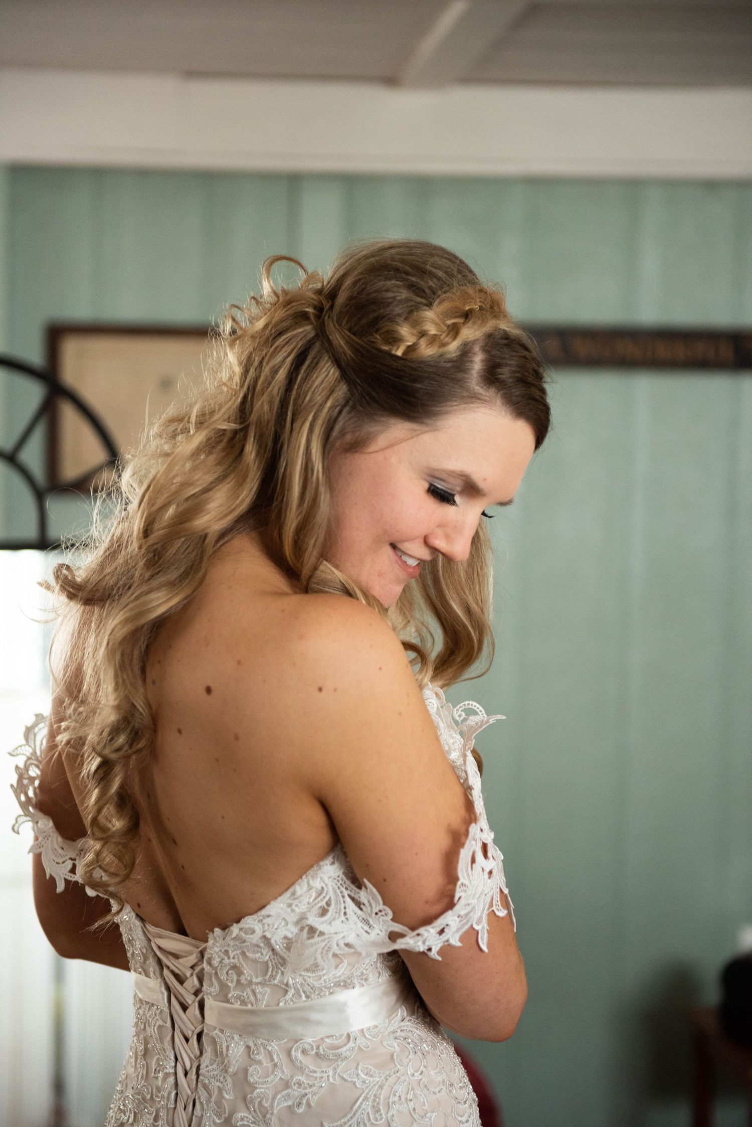 Detailed lace bodice of a wedding dress with delicate off-shoulder straps.