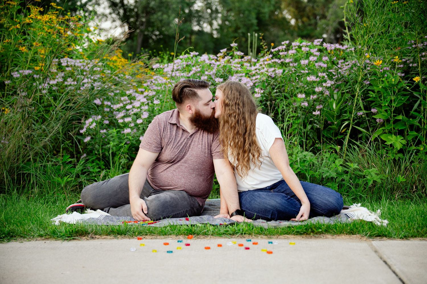Romantic couple relaxes in a wildflower meadow on a sunny day.