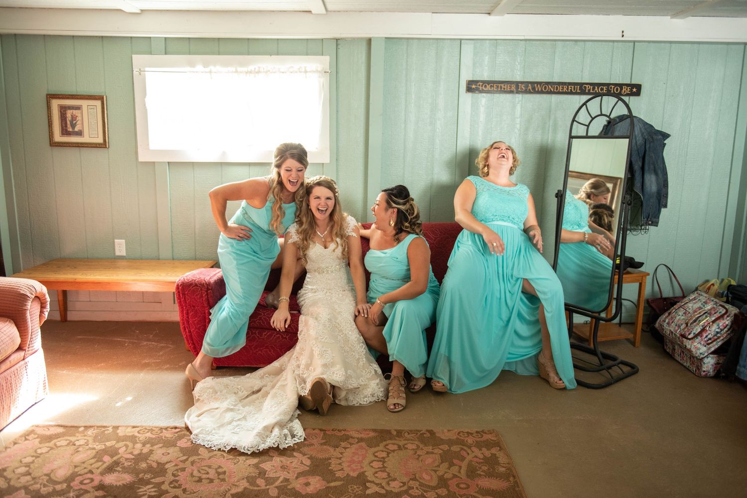 Wedding party lounging in a rustic room with mint green walls and vintage decor. Rum River Barn Milaca Minnesota Weddings