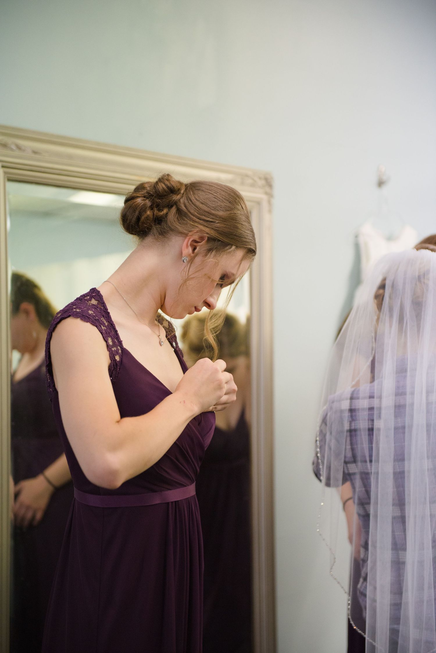 Preparations for a wedding day with bridesmaids in elegant purple dresses getting ready in front of a mirror. Andover wedding at Magestic Oa