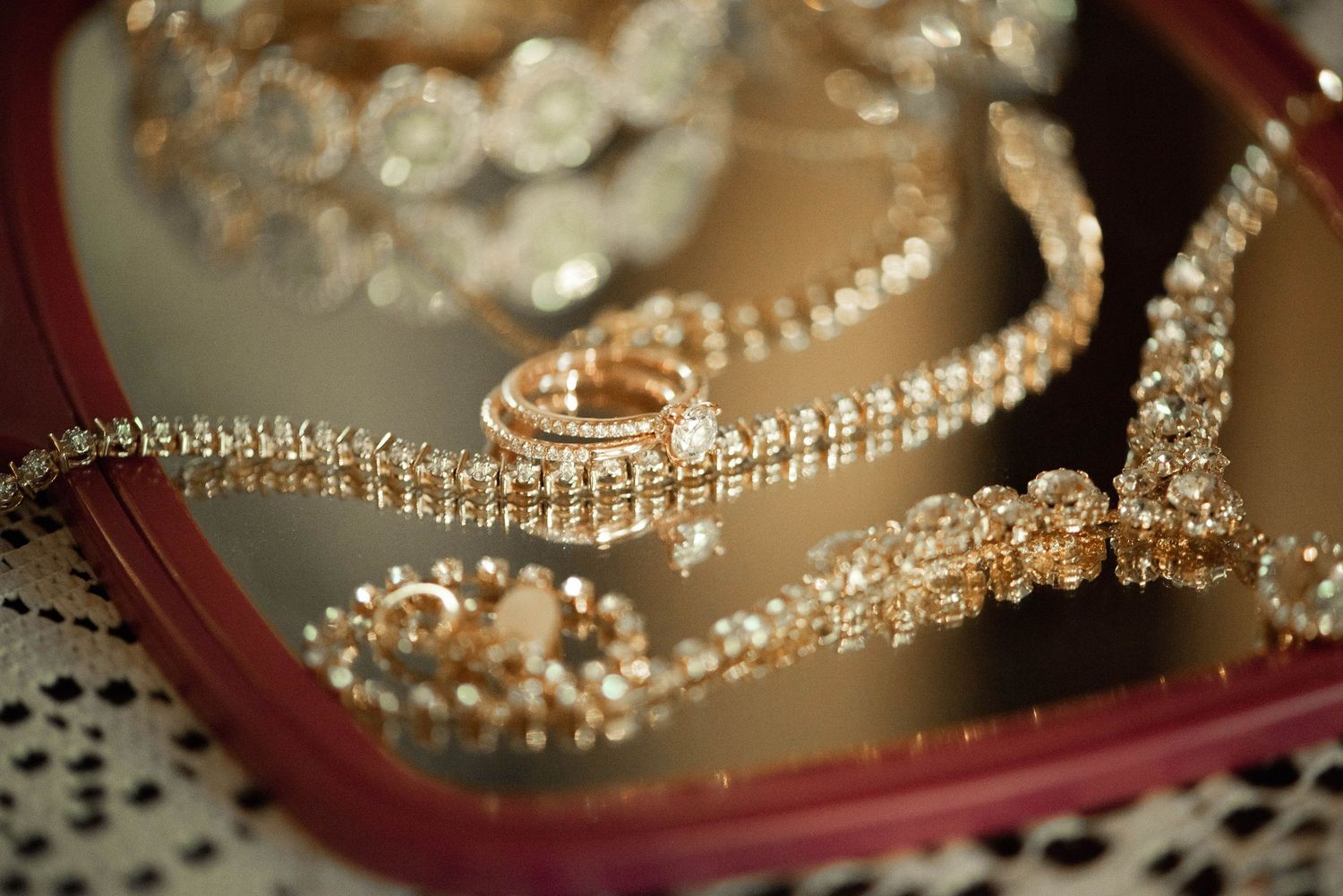 Beautiful pearls and diamonds jewelry pieces arranged artistically on wedding stationery.