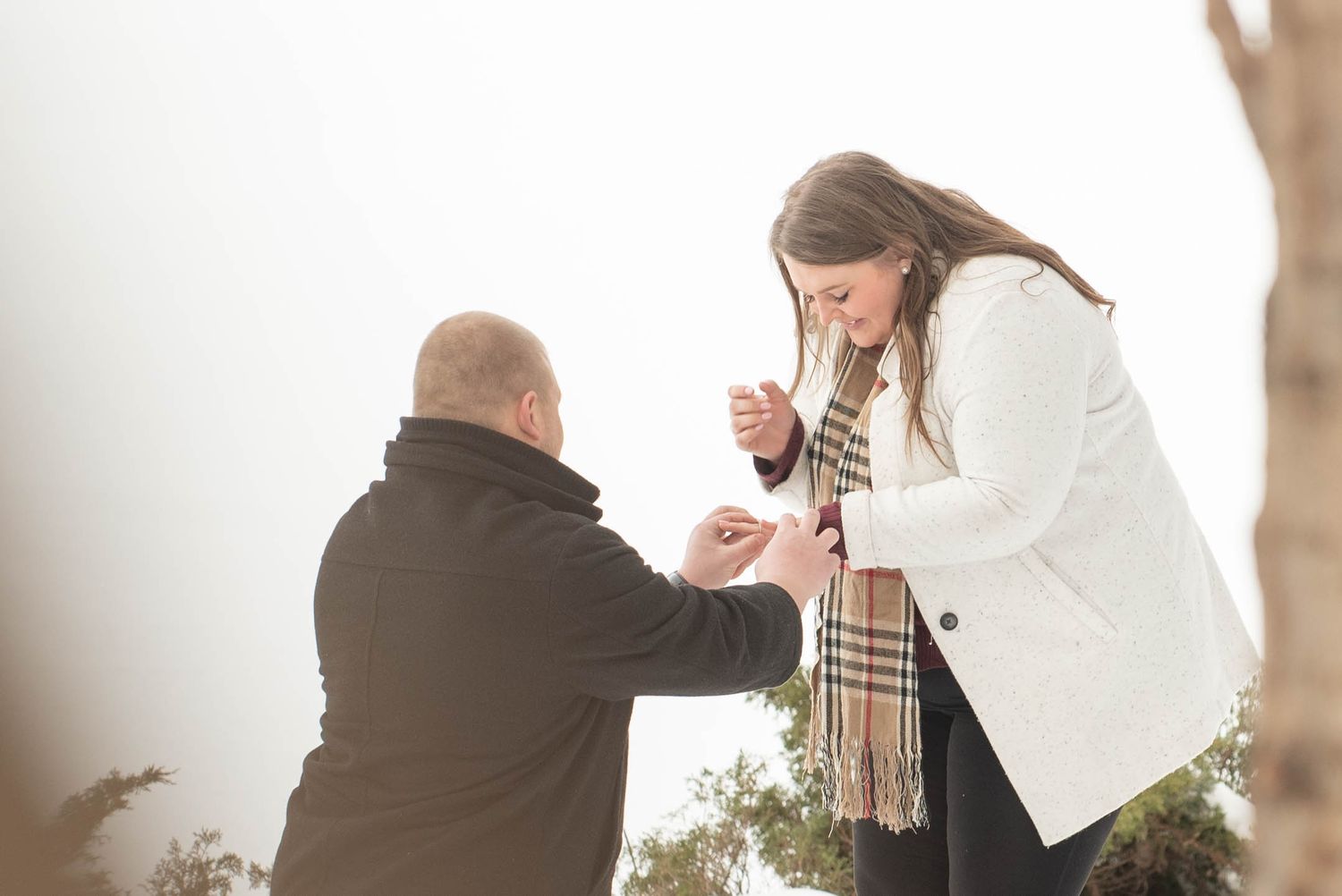 Special moment captured in an outdoor setting with white backdrop and natural lighting.