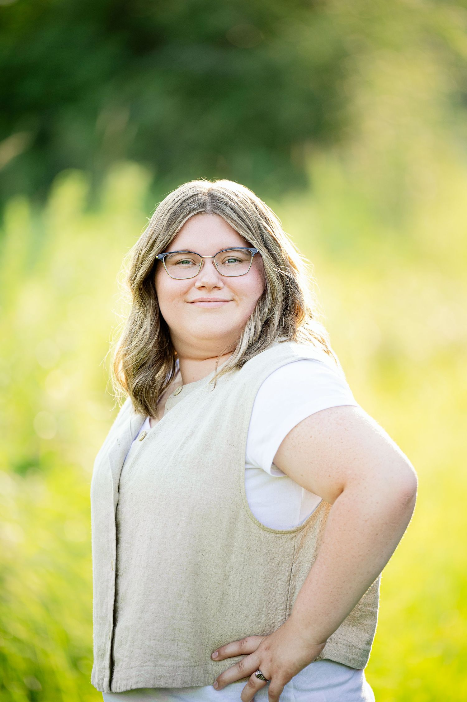 Senior Portrait in Foreston MN Summer portrait in natural light showing playful expressions against a bright yellow background.