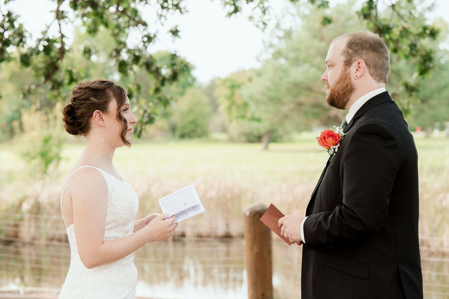 The Grands At Mulligans. Private vows Bride and groom share a tender first look moment in outdoor garden setting.