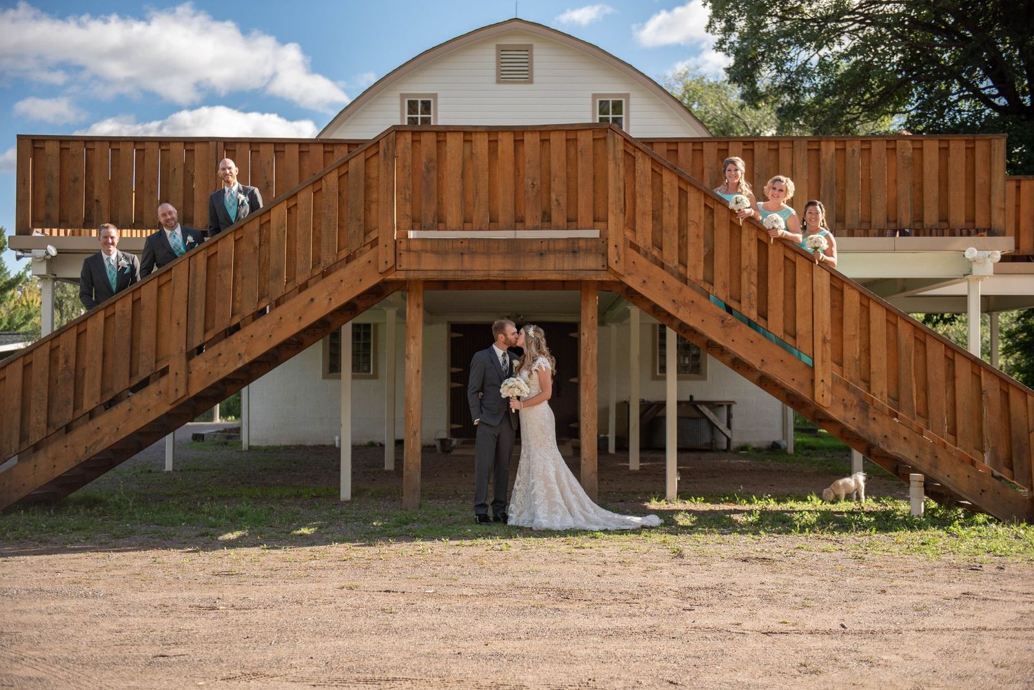 Rustic barn wedding venue with wooden staircase framing a romantic couple's portrait. Rum River Barn Milaca Minnesota Weddings