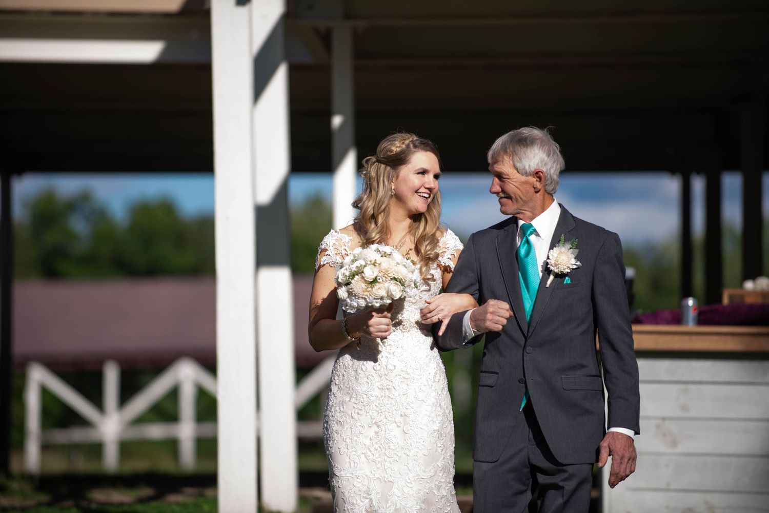 Elegant wedding portrait captured under covered outdoor venue in natural lighting. Rum River Barn Milaca Minnesota Weddings