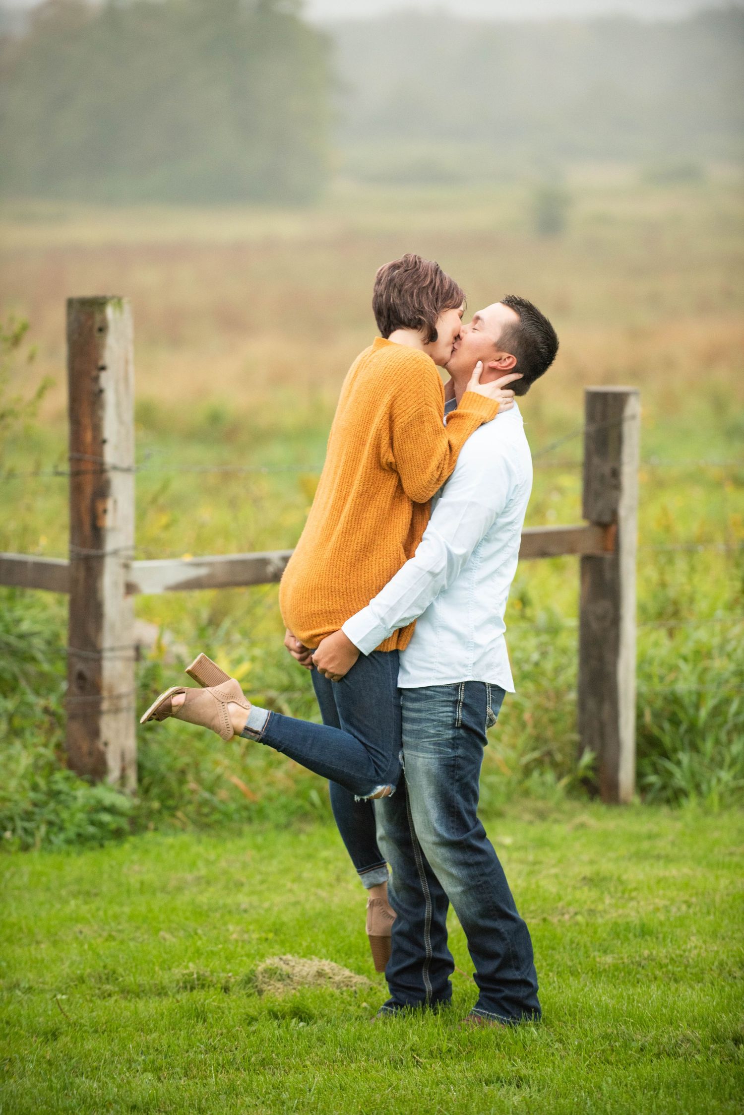 A sequence of photos in a grassy field showing a sweet interaction moment between two people on a misty day.