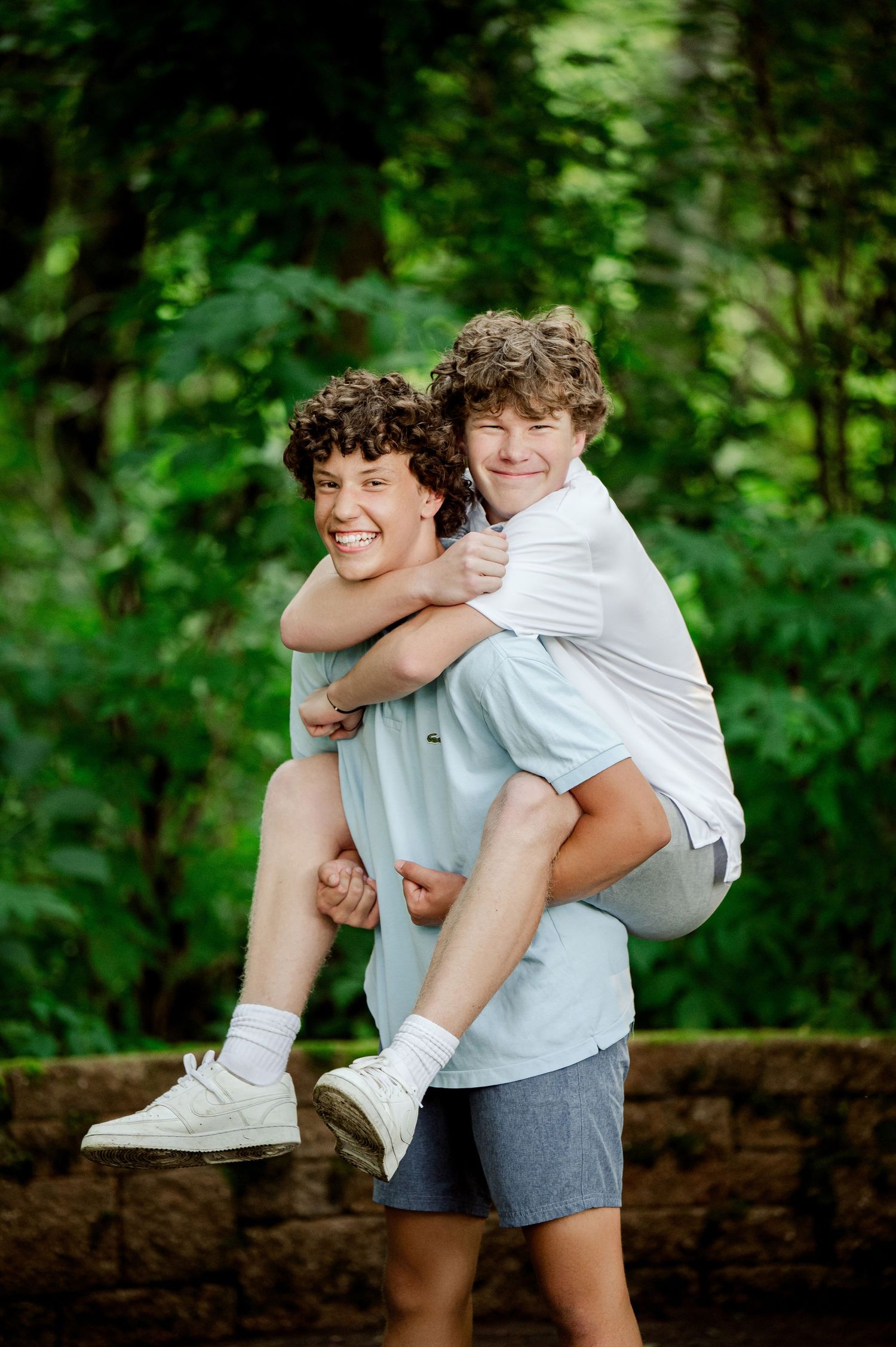 Clear Lake Family Photography: Playful outdoor photoshoot sequence with two people in white shirts against a lush green background.