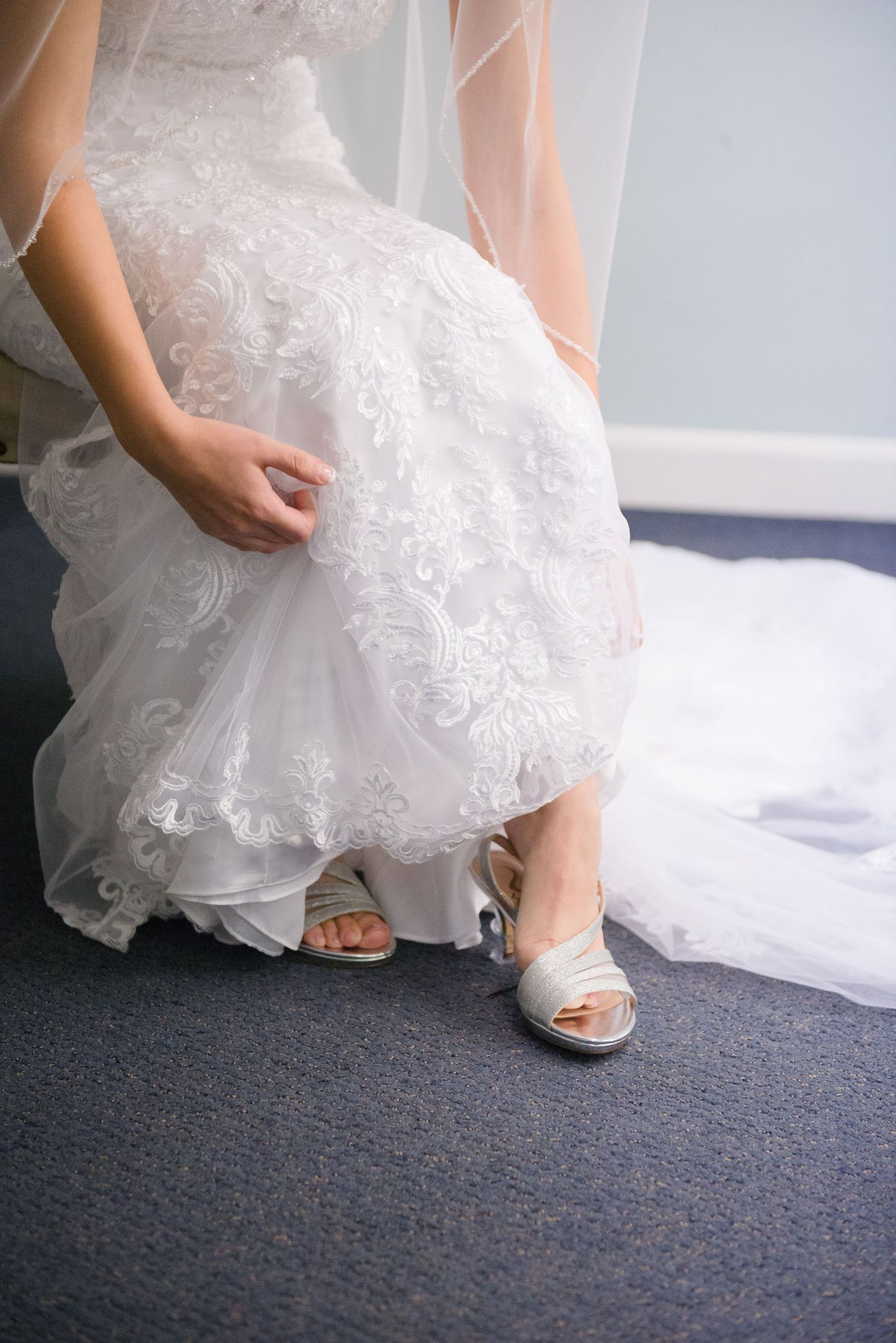 Silver peep-toe bridal shoes peeking out under layers of white tulle wedding dress. Andover wedding at Magestic Oaks Golf Club