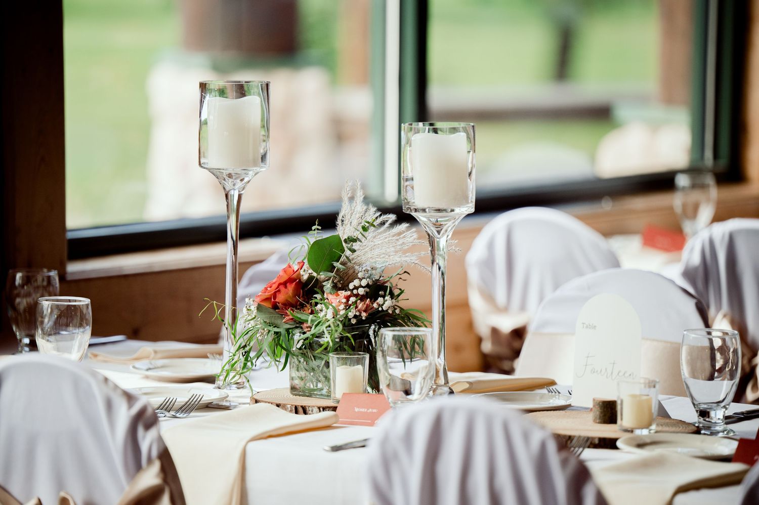 The Grands at Mulligans- Wedding Photos: Elegant wedding reception table settings with white linens, glassware and floral centerpiece