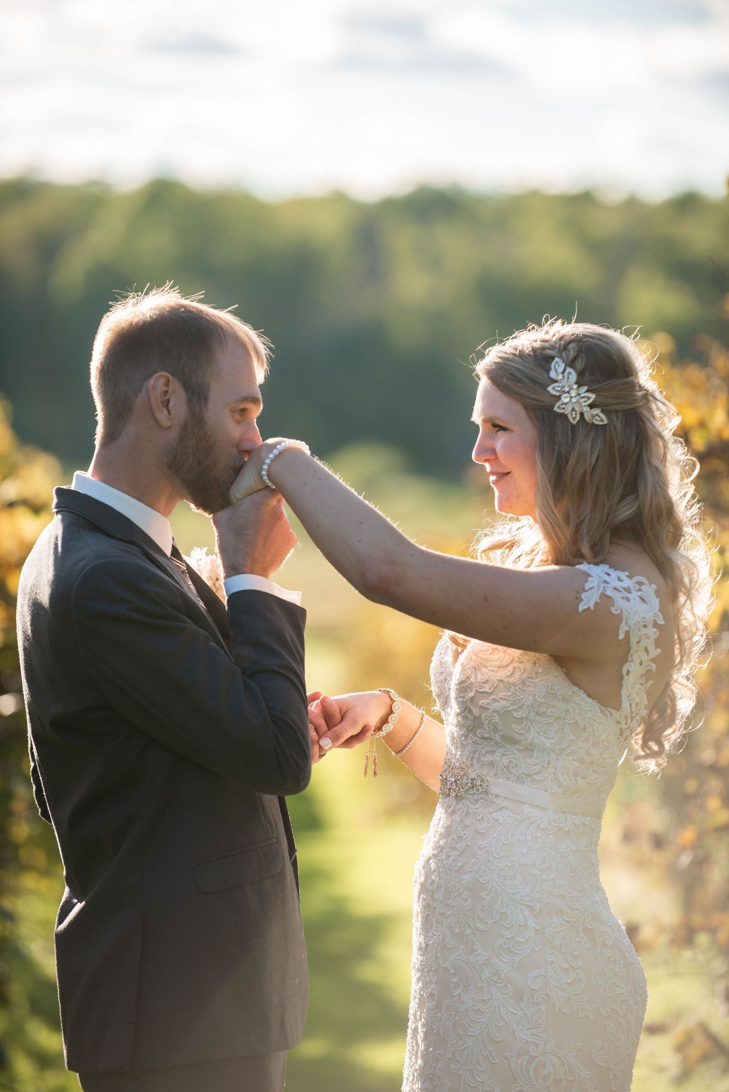 A tender moment between newlyweds during golden hour in a vineyard setting. Milaca Minnesota Weddings