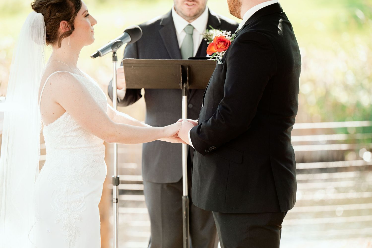 Wedding couple shares intimate first look moment in natural outdoor setting.