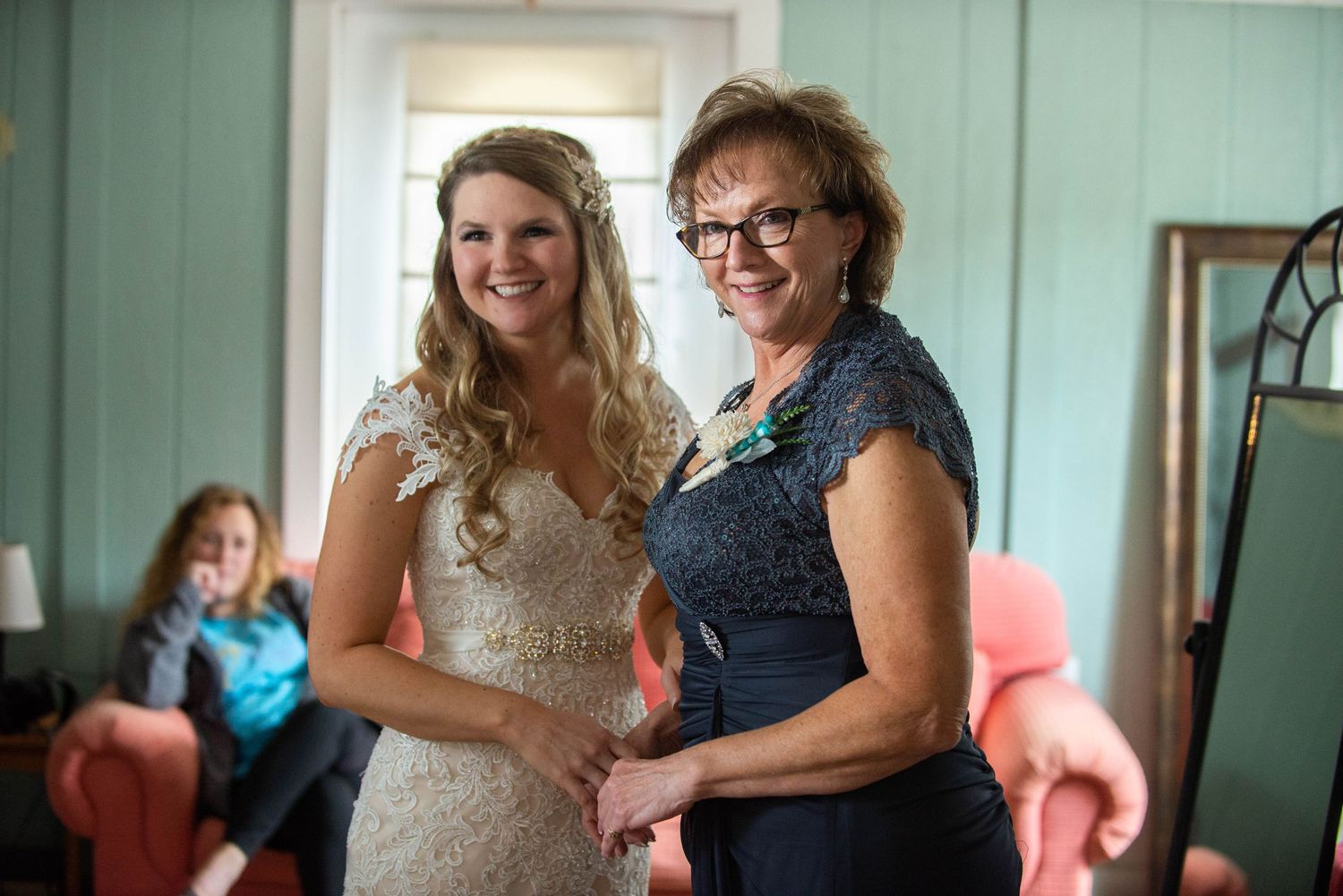 Getting ready photos in a mint-colored room with soft natural lighting. Rum River Barn Milaca Minnesota Weddings