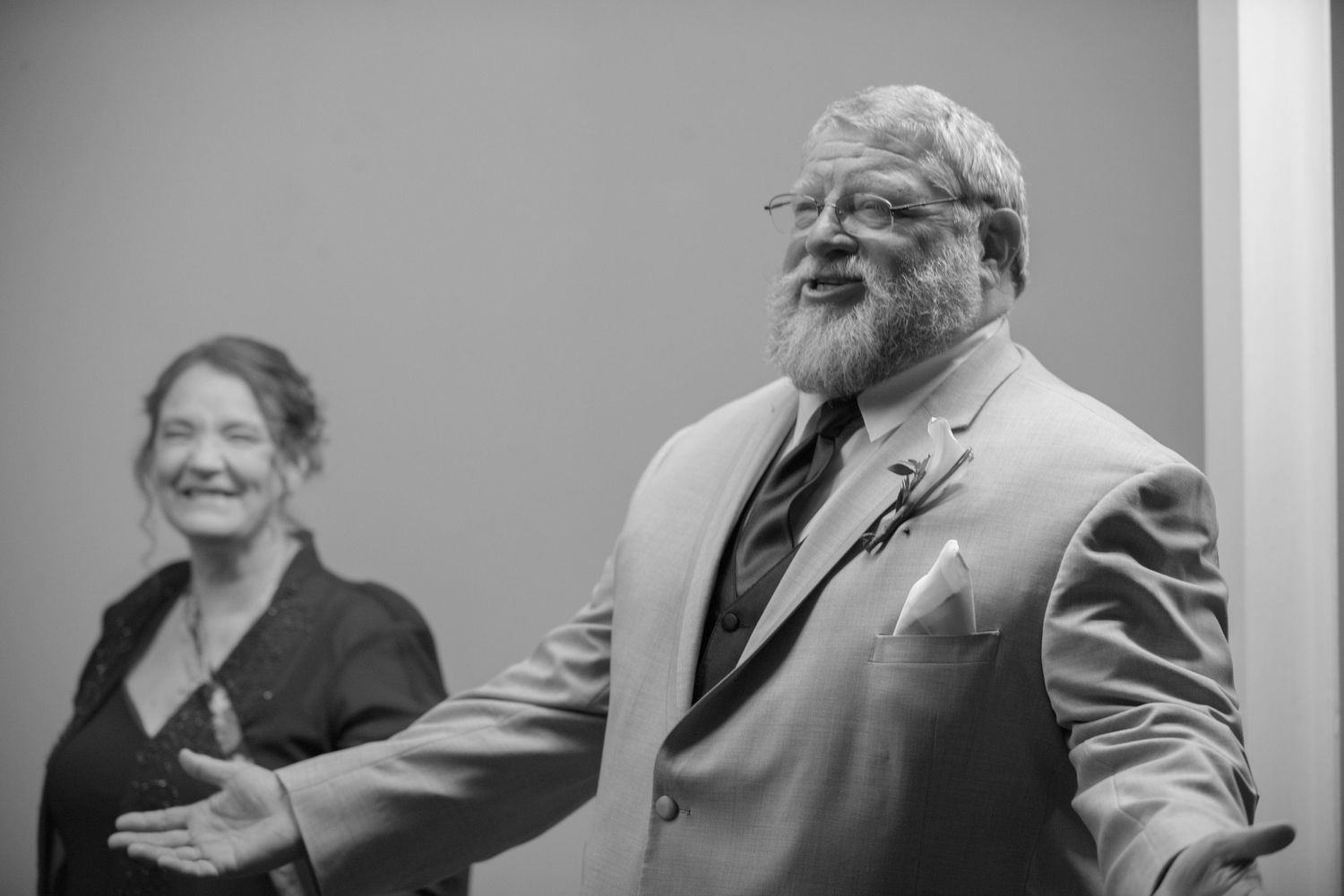 Two people sharing a candid laughing moment in black and white photography. Andover wedding at Magestic Oaks Golf Club