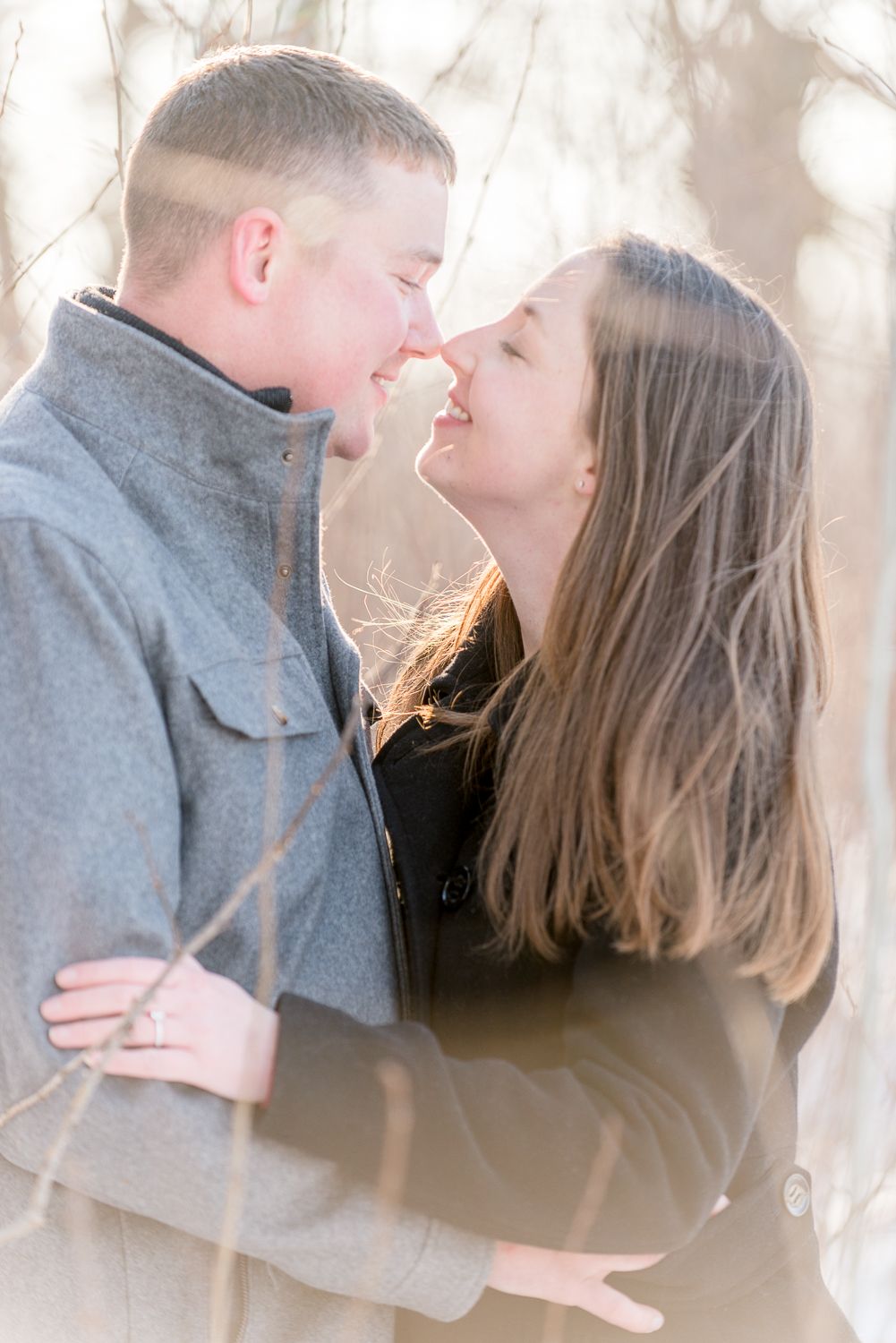A tender romantic moment captured in soft focus with a dreamy winter background.
