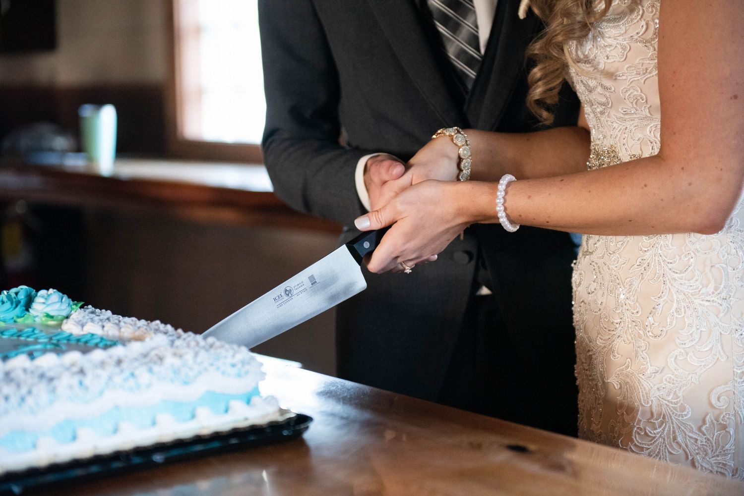 Hands shown exchanging cards or letters during wedding preparations. Rum River Barn Milaca Minnesota Weddings