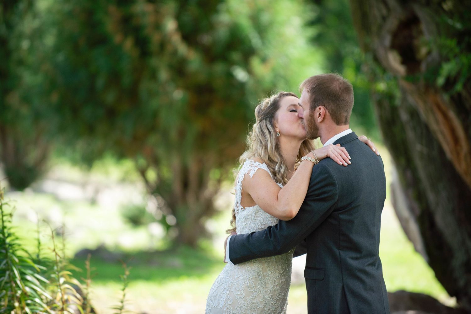 Romantic wedding portrait of couple embracing in garden setting. Rum River Barn Milaca Minnesota Weddings