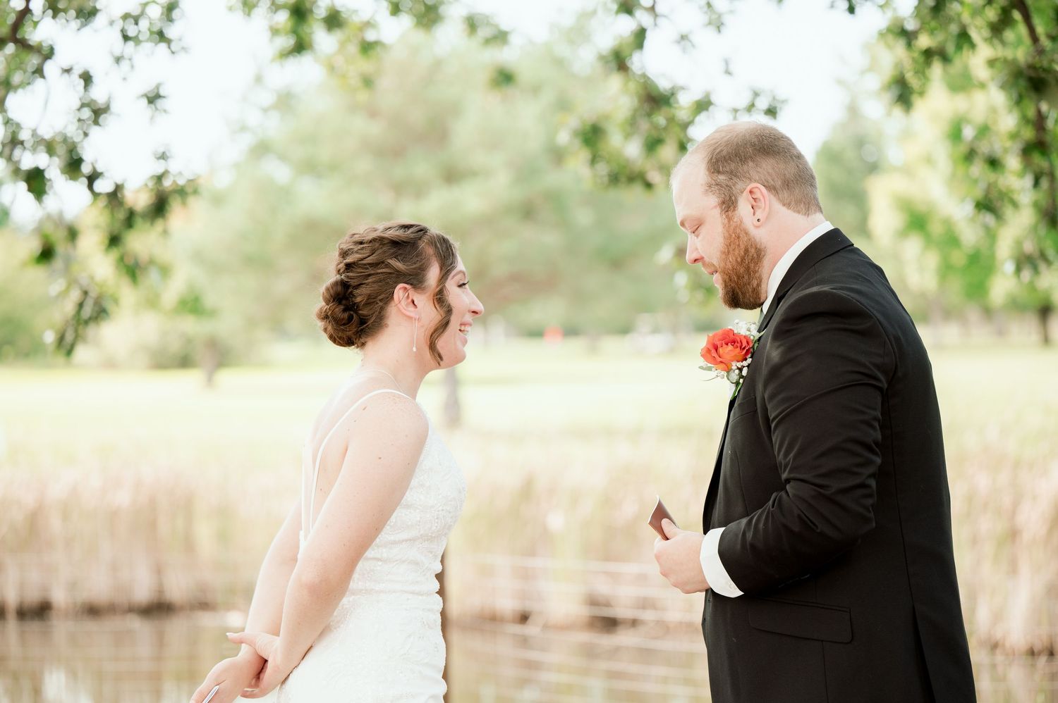 The Grands at Mulligans- Wedding Photos: A romantic moment between a bride in white and groom in black during an outdoor wedding