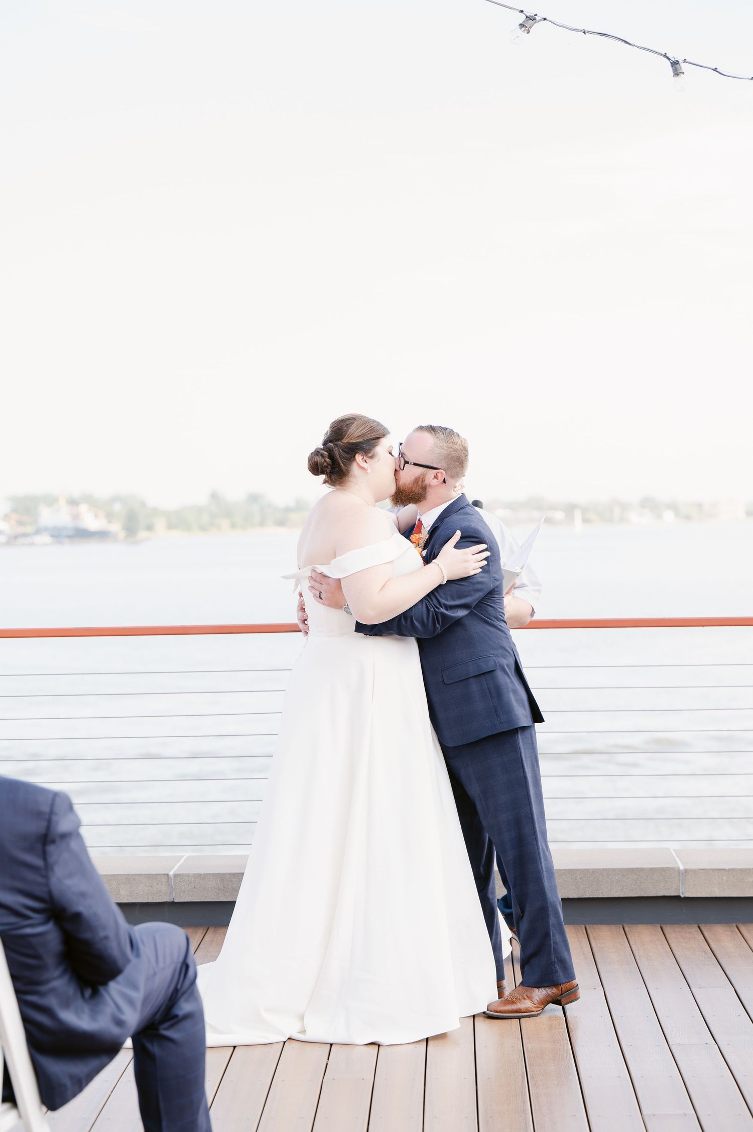 Pier B Duluth Wedding Romantic wedding moments captured on wooden deck overlooking waterfront.