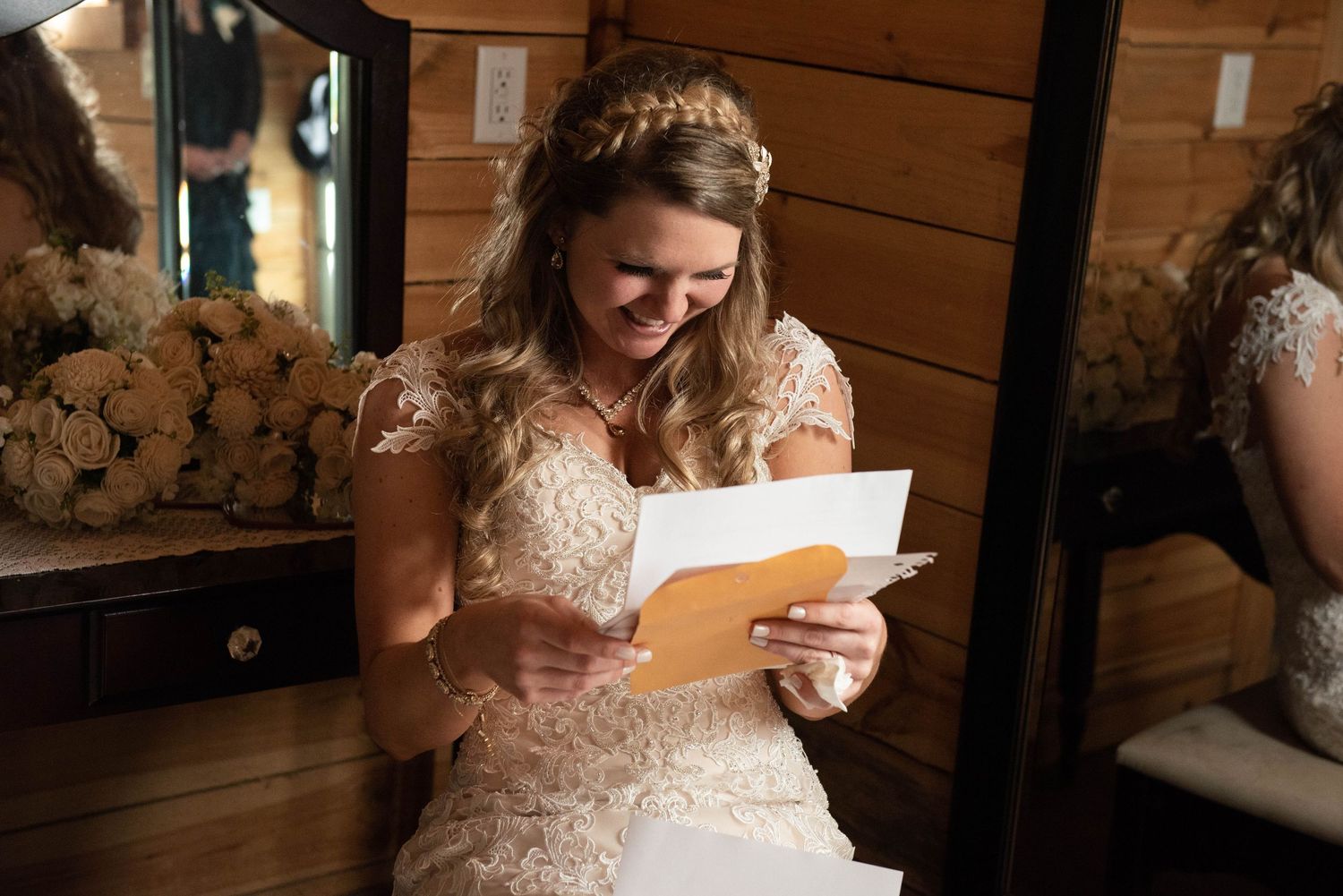 Wedding party members reading emotional letters and sharing intimate moments in rustic wooden setting. Rum River Barn Milaca Minnesota Weddi