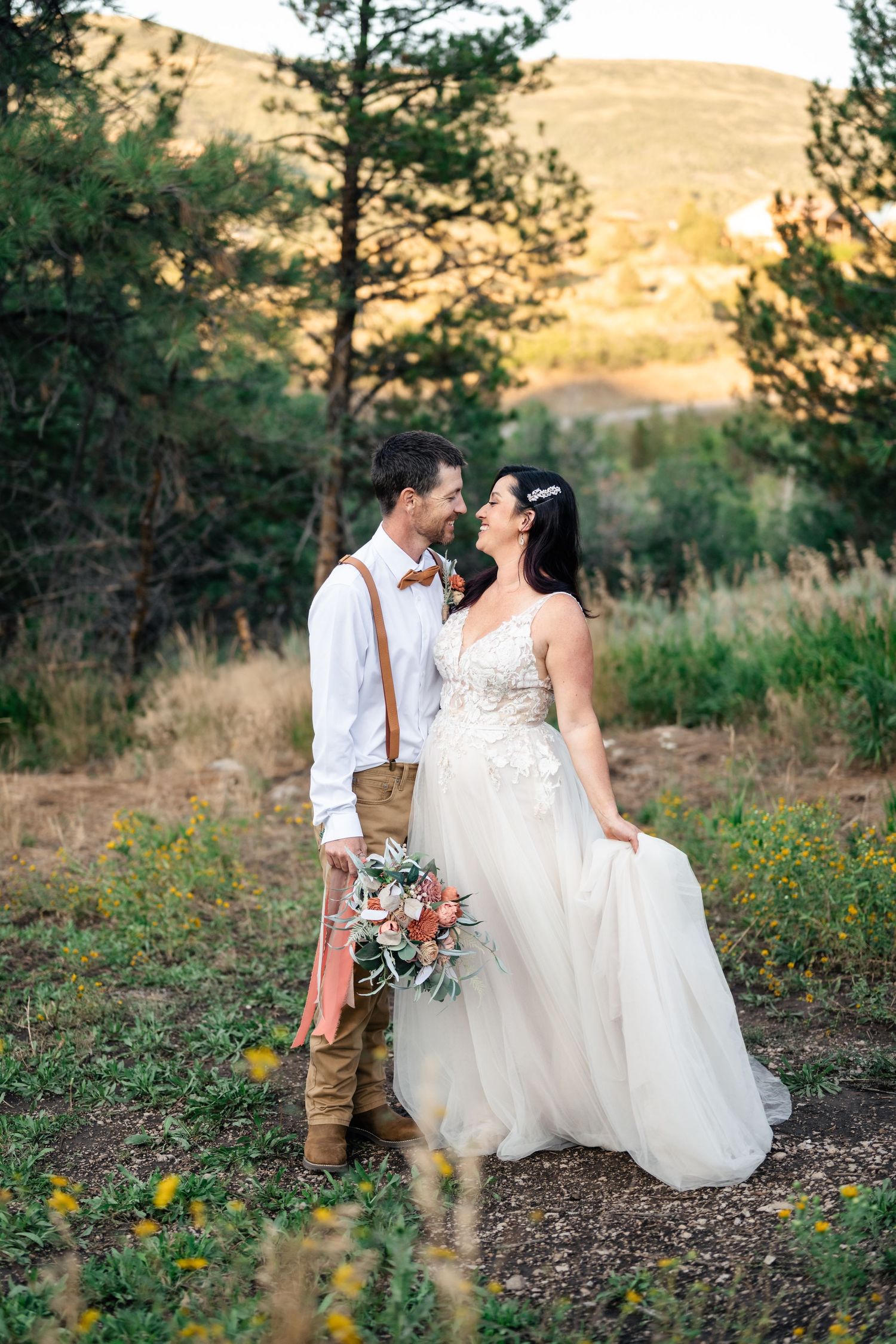 Wedding couple smiles to each other in the mountains of Park City captured by Utah Wedding photographer Coley Cook.