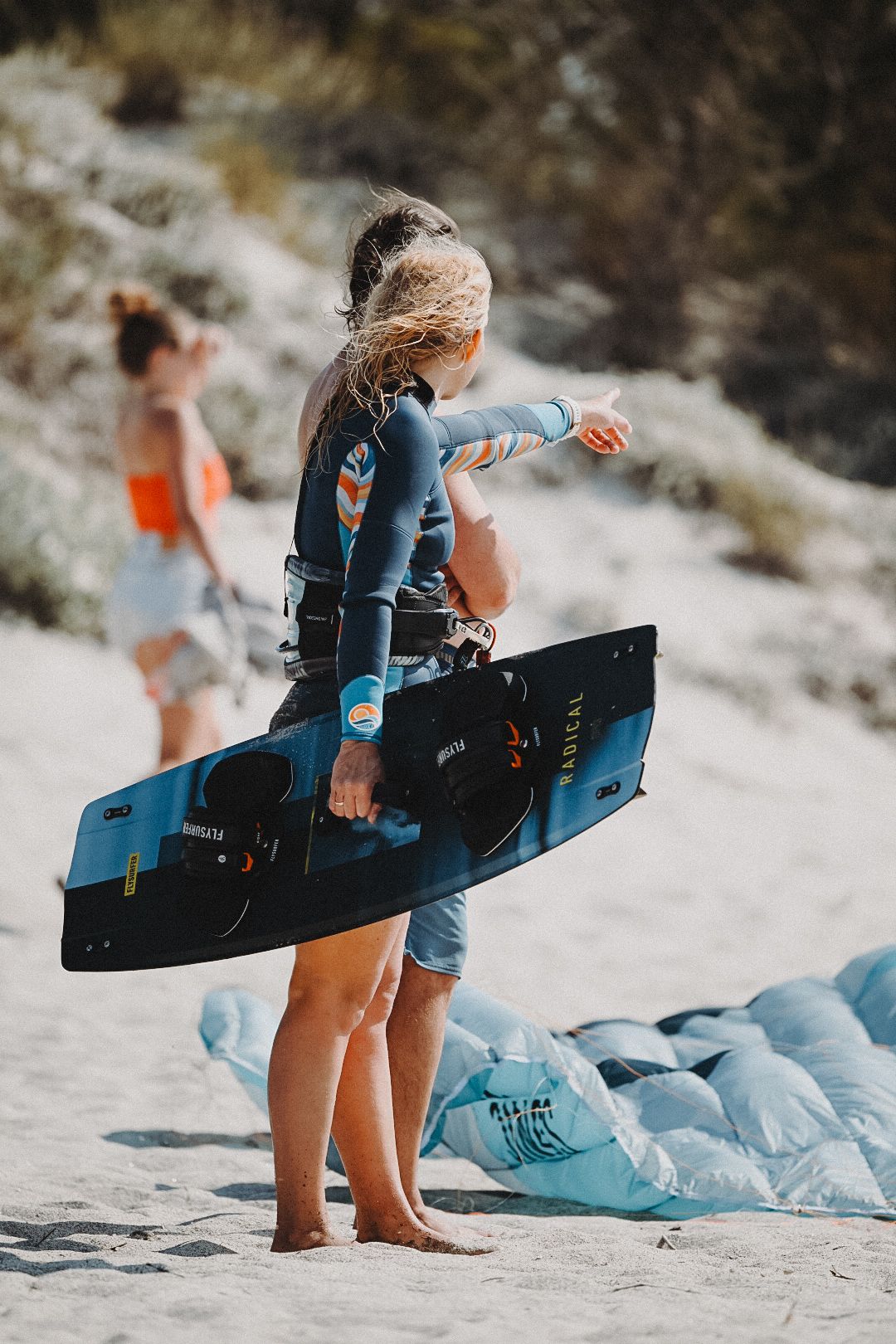 Scene of two people on a beach, kitesurfing, Mastichari Greece