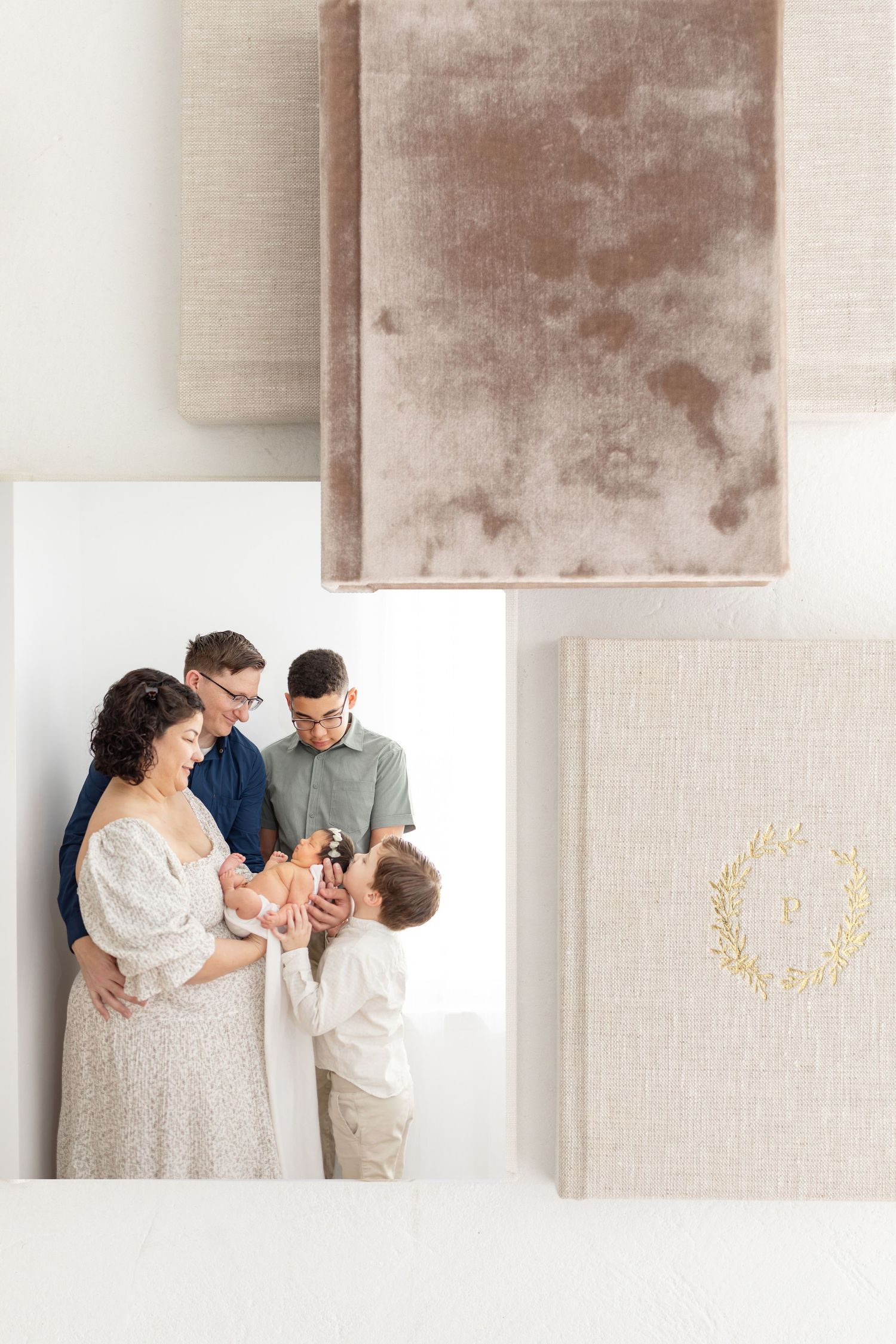 A tender family moment captured in soft neutral tones alongside an elegant beige velvet book with gold foil details.