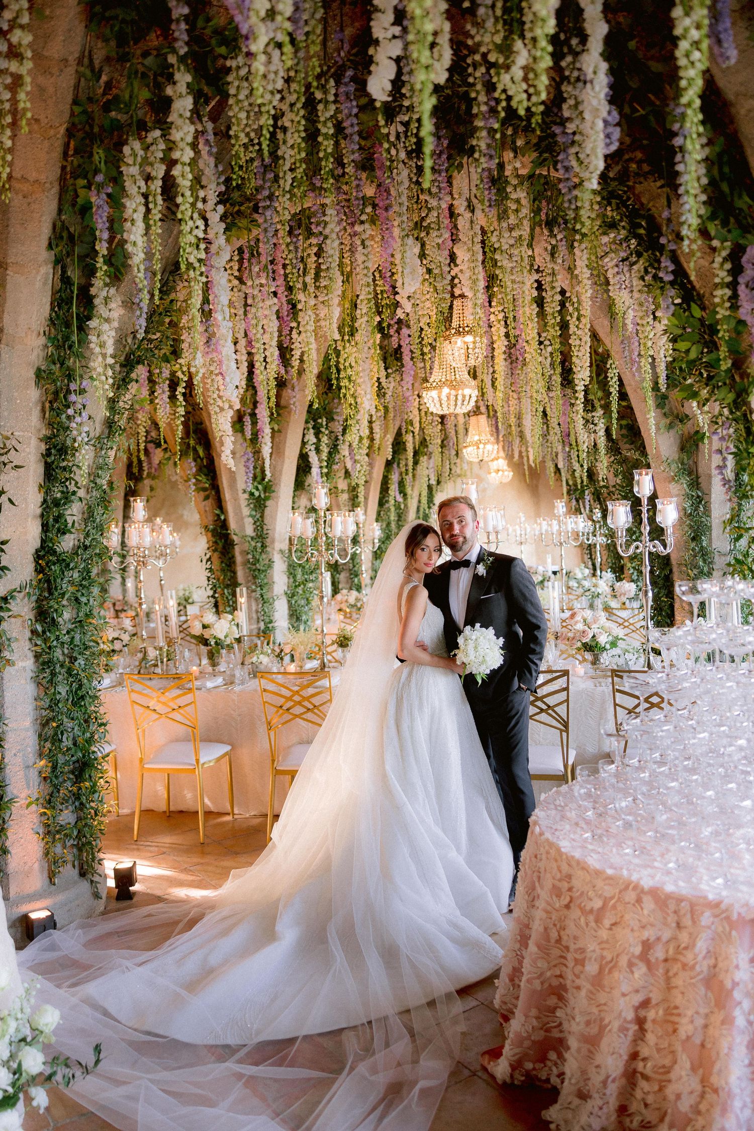 Elegant crypt of Villa Cimbrone decorated with cascading floral vines and crystal chandeliers creating a magical garden atmosphere.