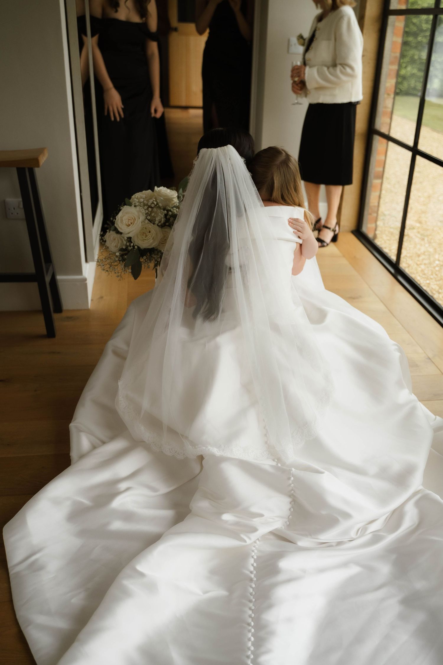 bride and flower girl hug at Primrose Hill farm Wedding- Photo by Primrose Hill Farm Wedding Photographer, Olivia J Morgan Photography