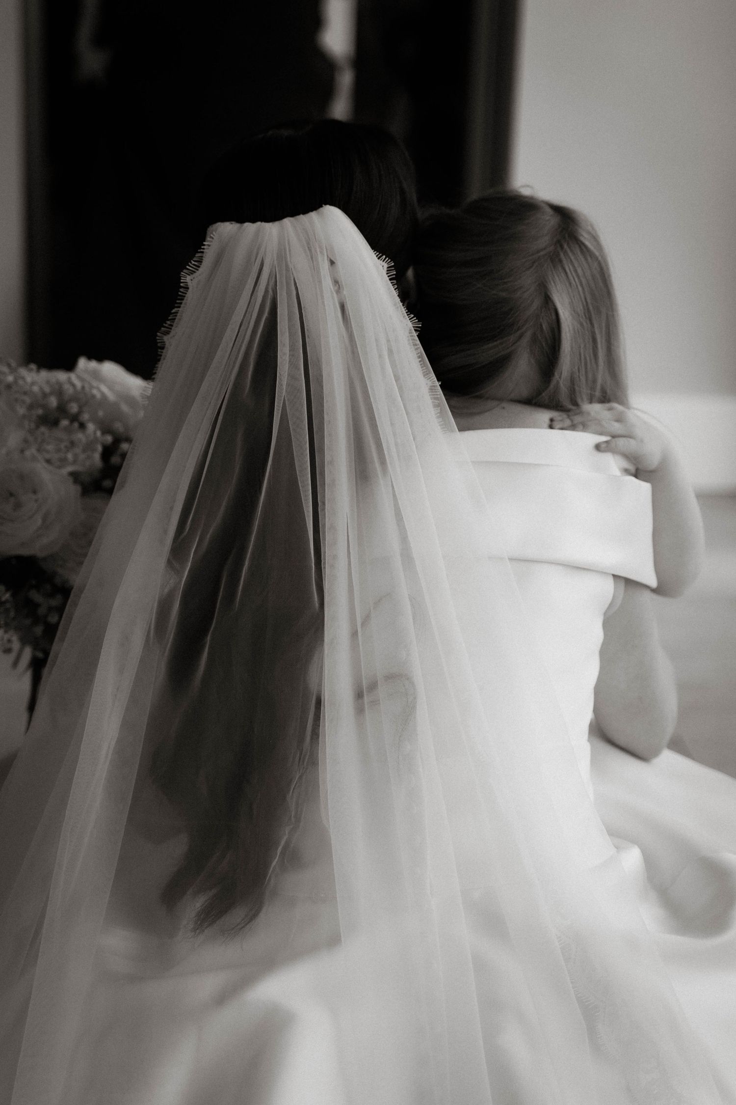 bride and flower girl hug at Primrose Hill farm Wedding- Photo by Primrose Hill Farm Wedding Photographer, Olivia J Morgan Photography
