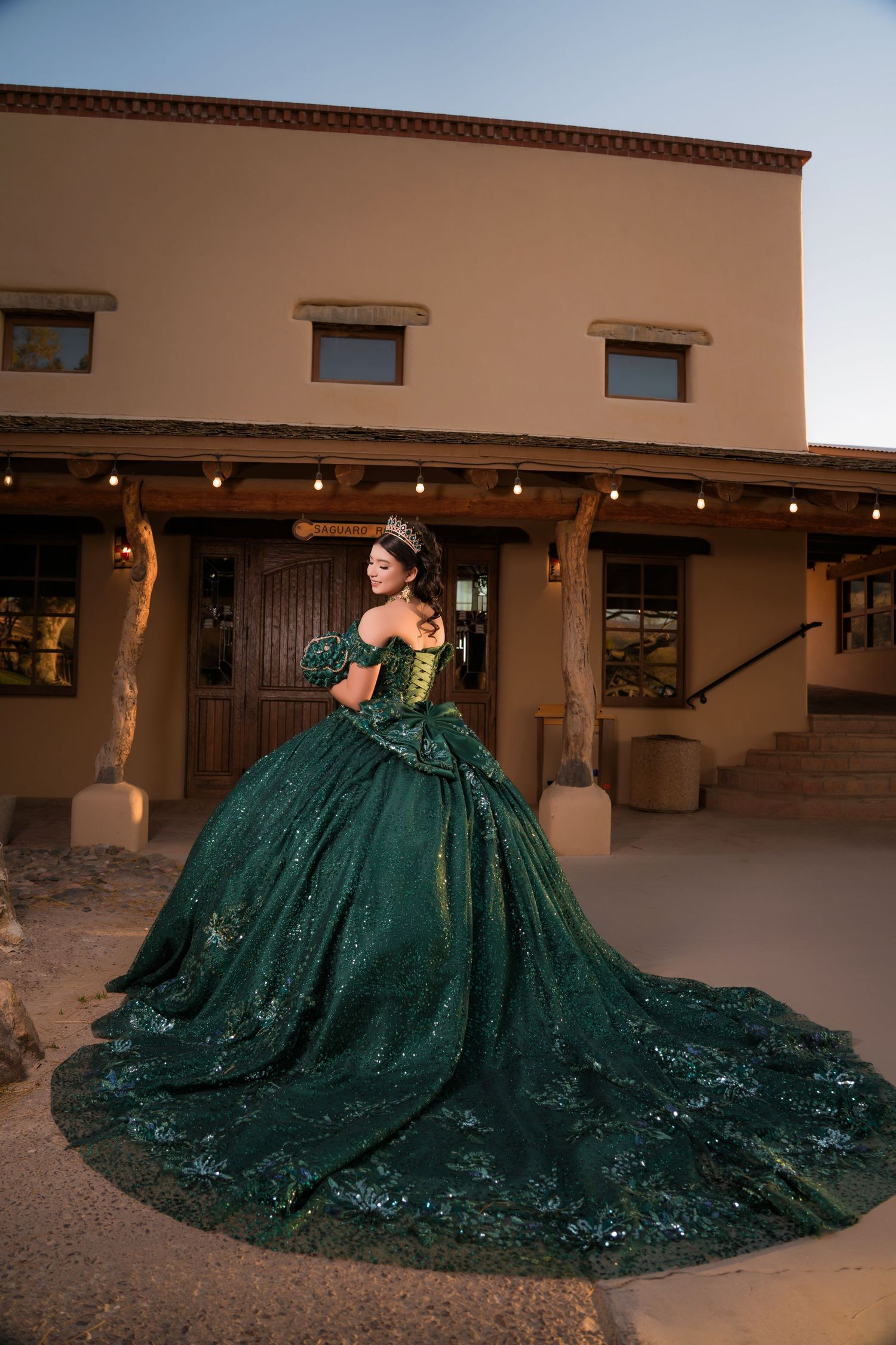 Quinceañera in elegant green dress posing during pre-session at Tucson desert location
