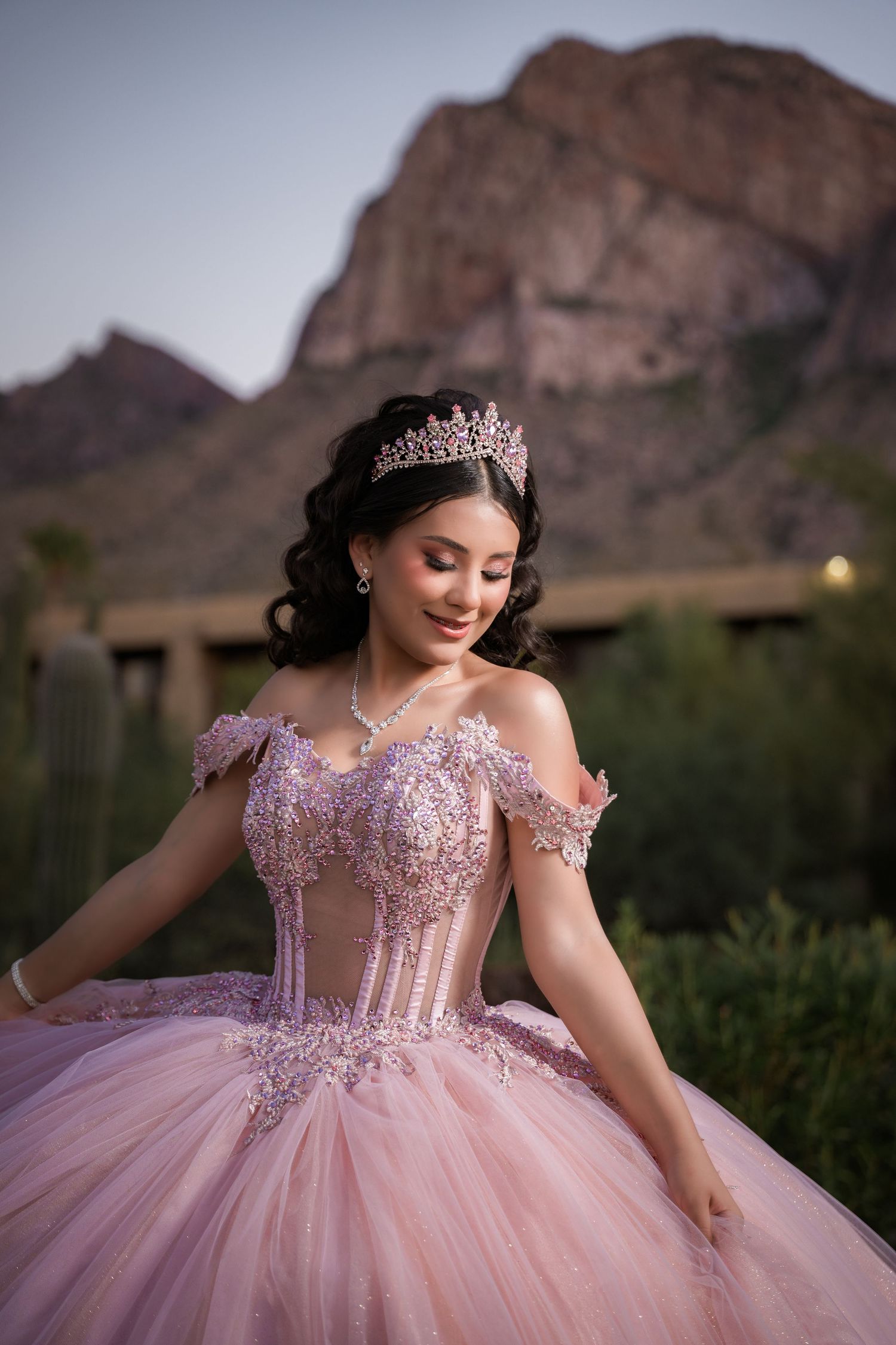 Quinceañera in elegant pink dress posing during pre-session at Tucson desert location