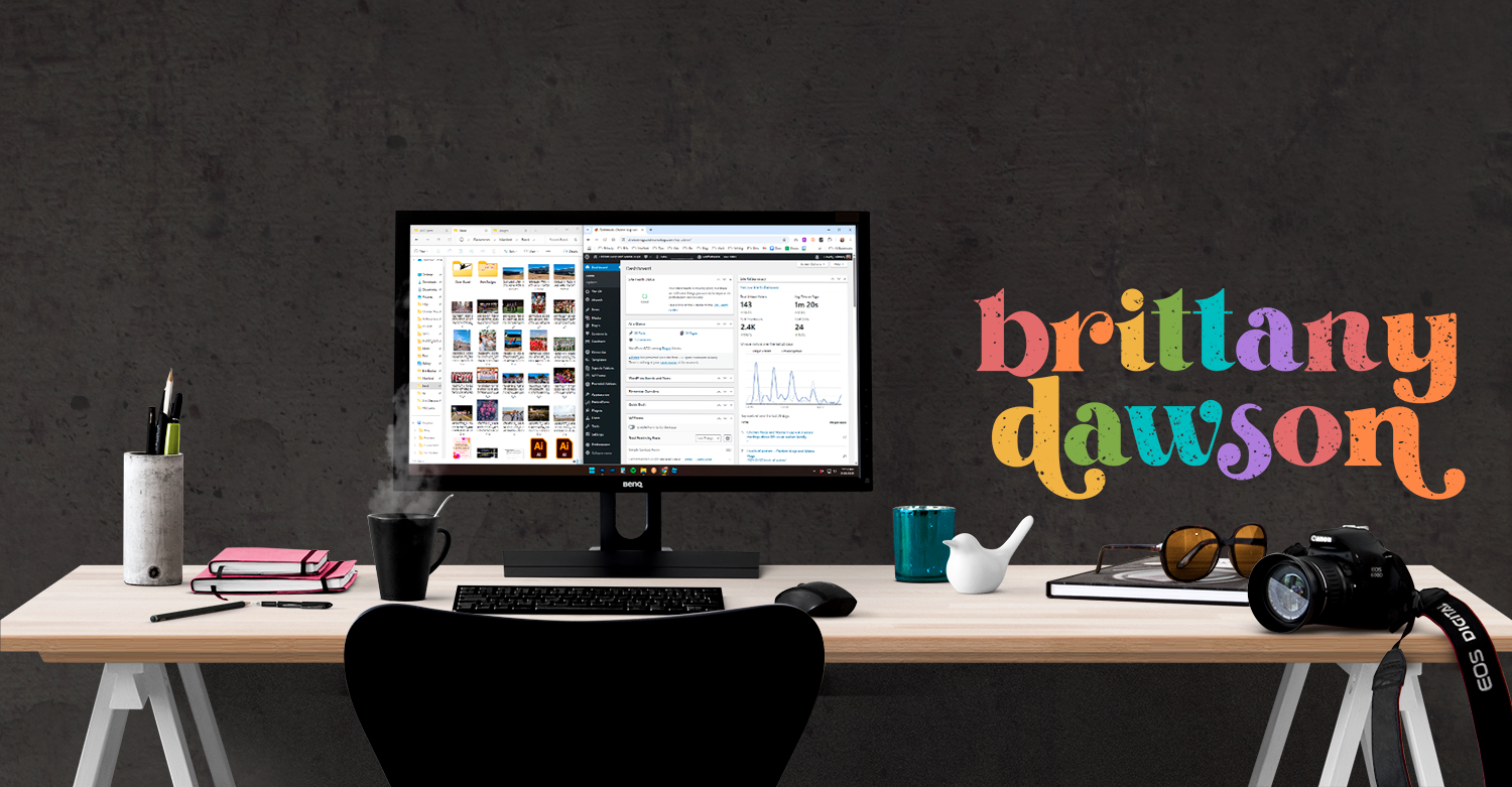 Modern dark workspace setup with rainbow text design elements.