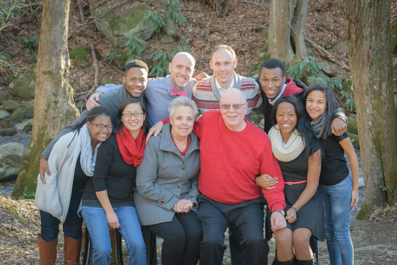 pigeon forge family photographers portrait of a loving hug reunion against brown background in Tennessee.