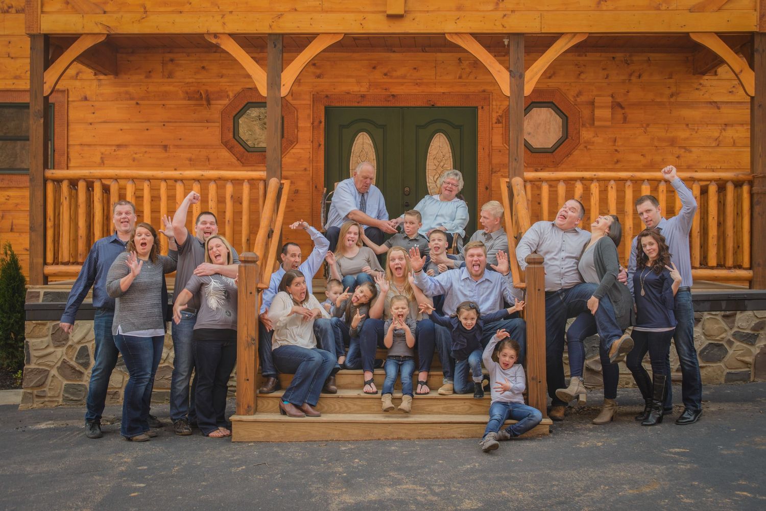 A large group wearing matching navy and white outfits poses together on wooden cabin steps for a coordinated photo in Townsend TN.