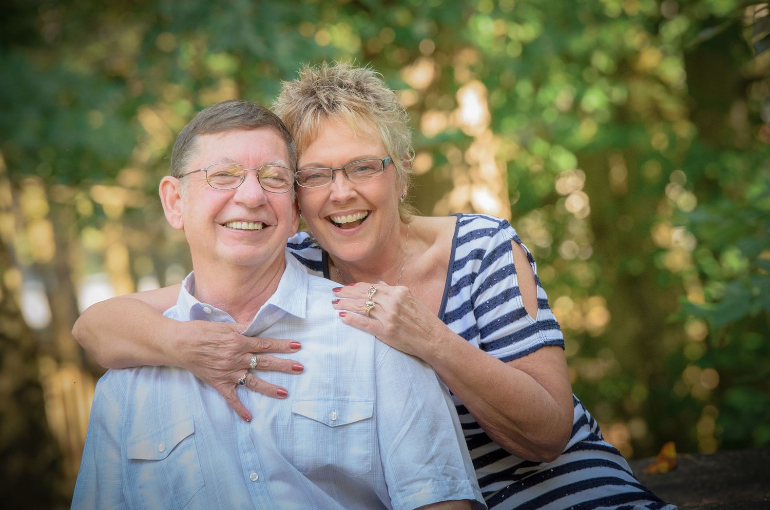 Townsend Photographer portrait of a happy elderly couple sharing a joyful moment together outdoors with a natural greenery background.
