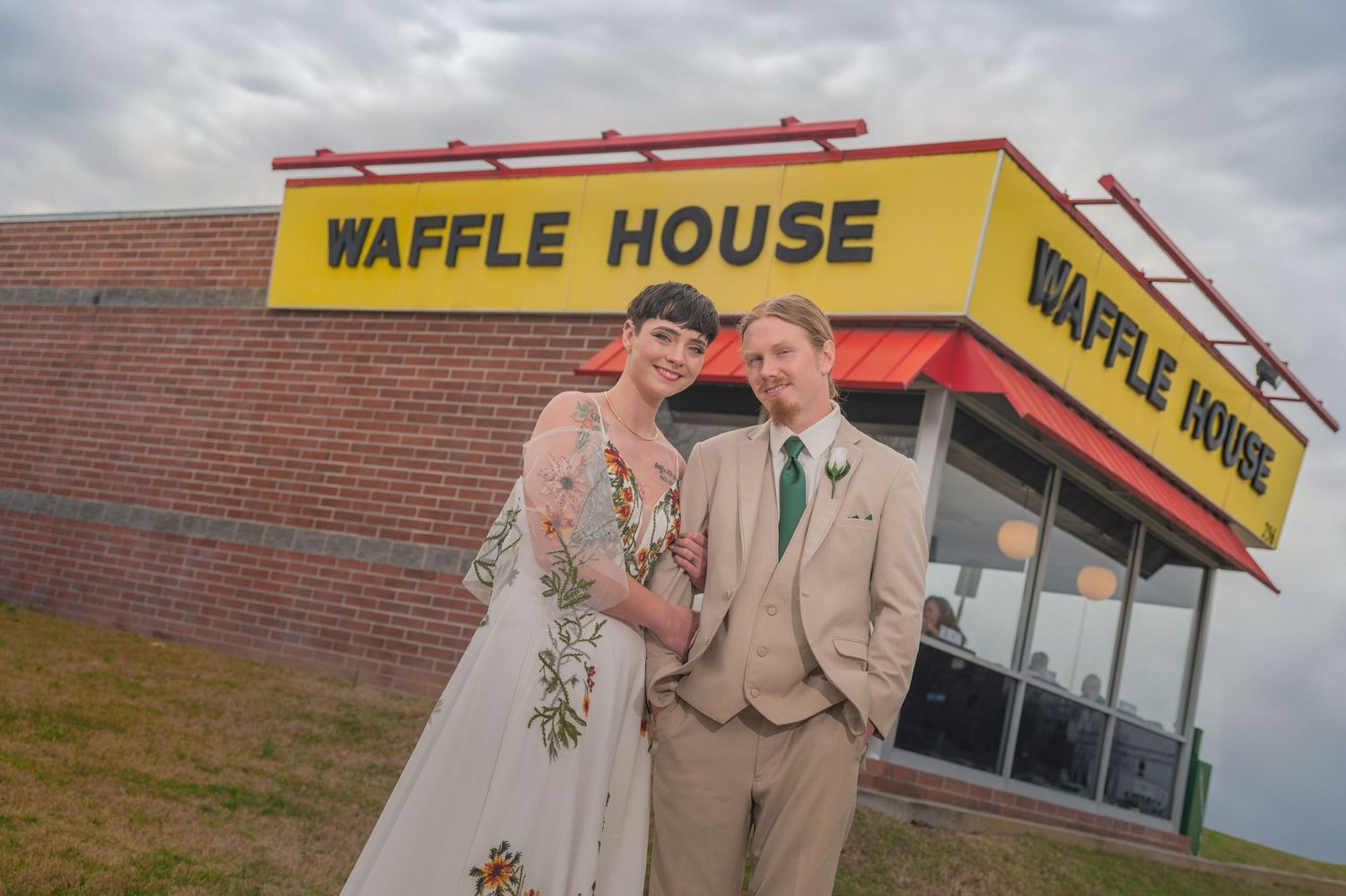 A couple in wedding attire poses together outside a Waffle House restaurant on their special day by Gatlinburg Wedding Photographers.