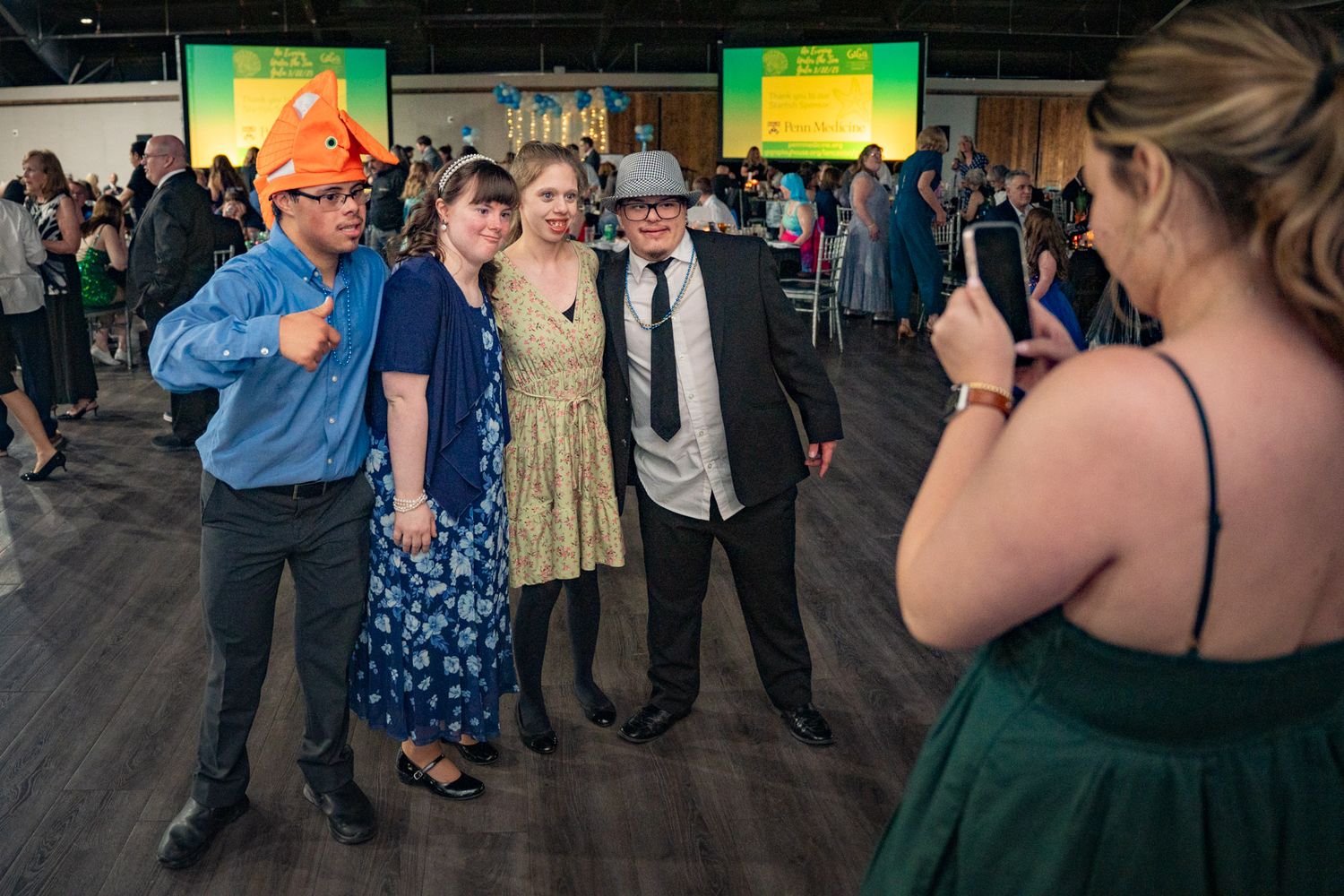 grip and grin photo of young people at a gala