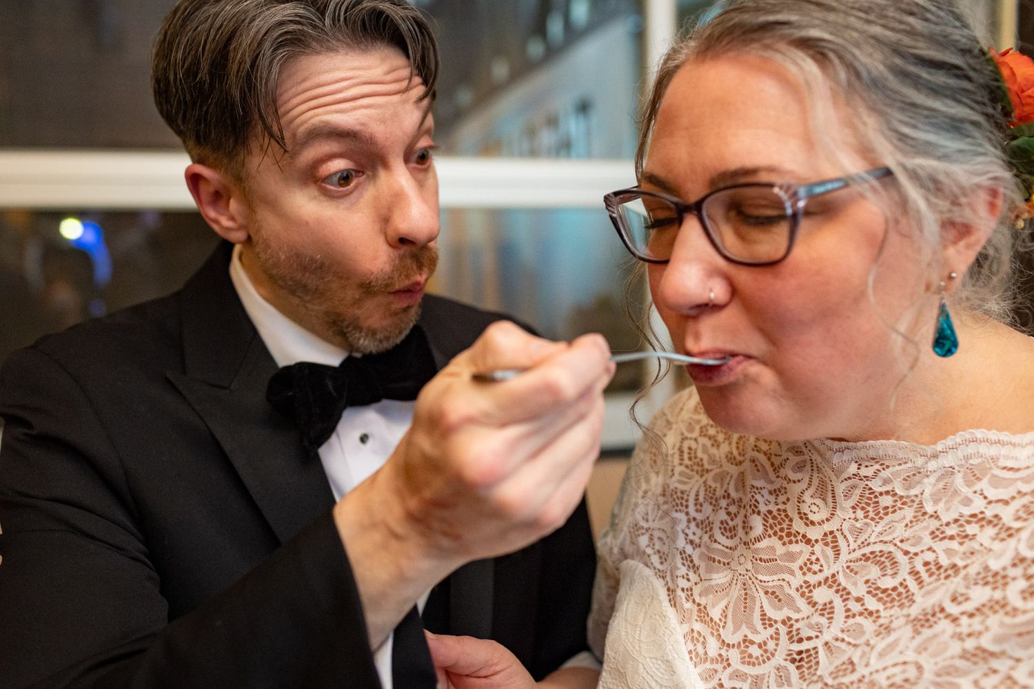 groom feeding cake to the bride