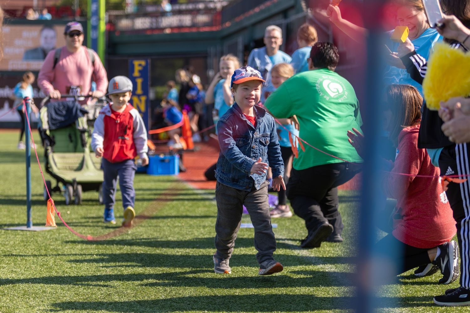 Participants spread across baseball field during outdoor community event.