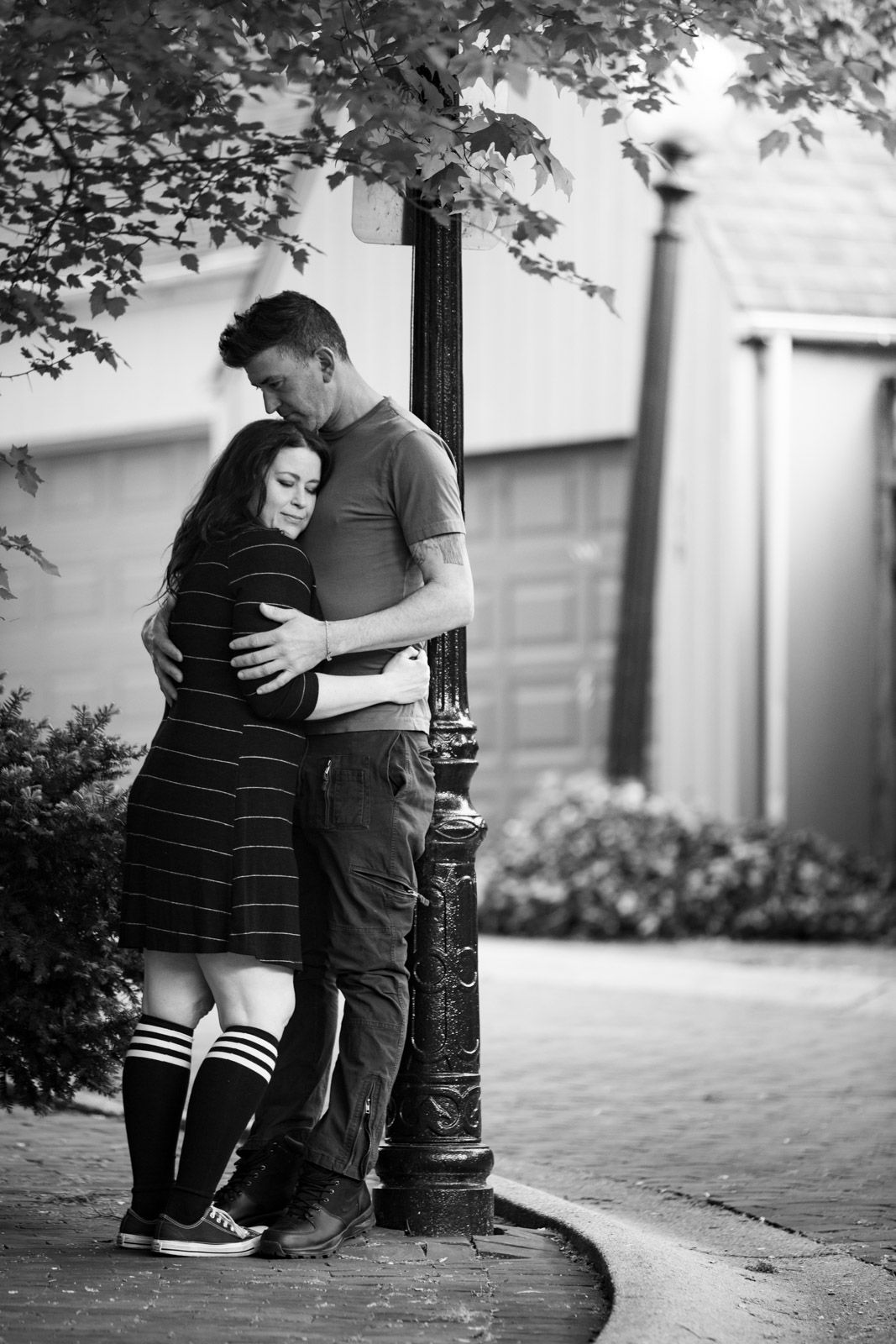Leaning against a light post, photo