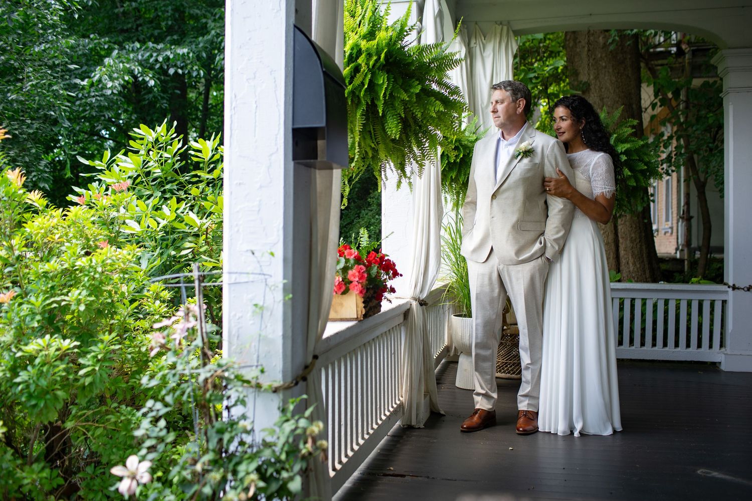 Joyful candid moments captured of a family on an outdoor porch surrounded by lush greenery.
