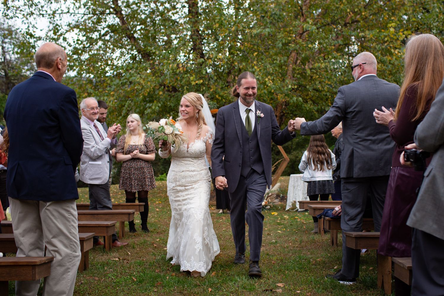 wedding recessional with bride and groom smiling