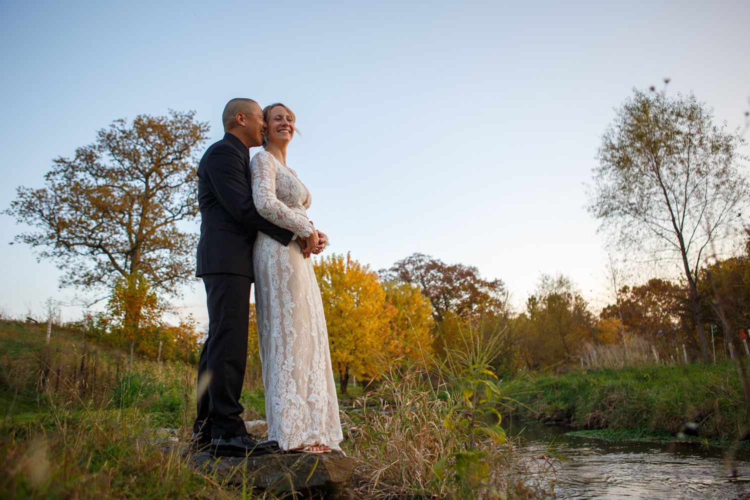 couple kissing by a stream