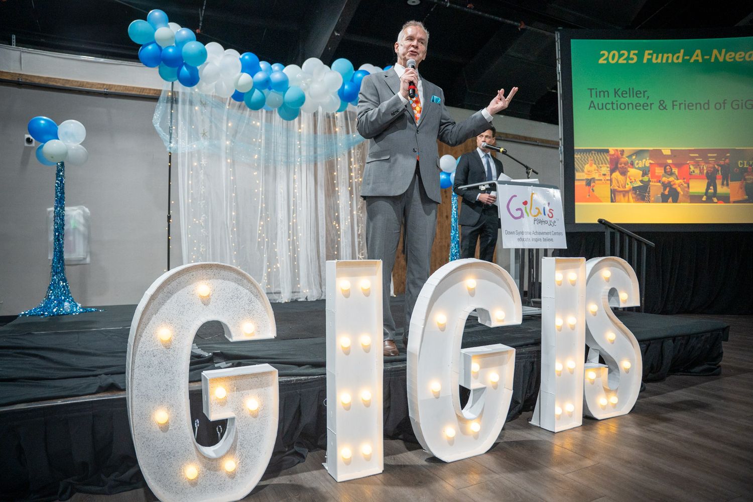 Giant letters G I G I S at a gala during an auction