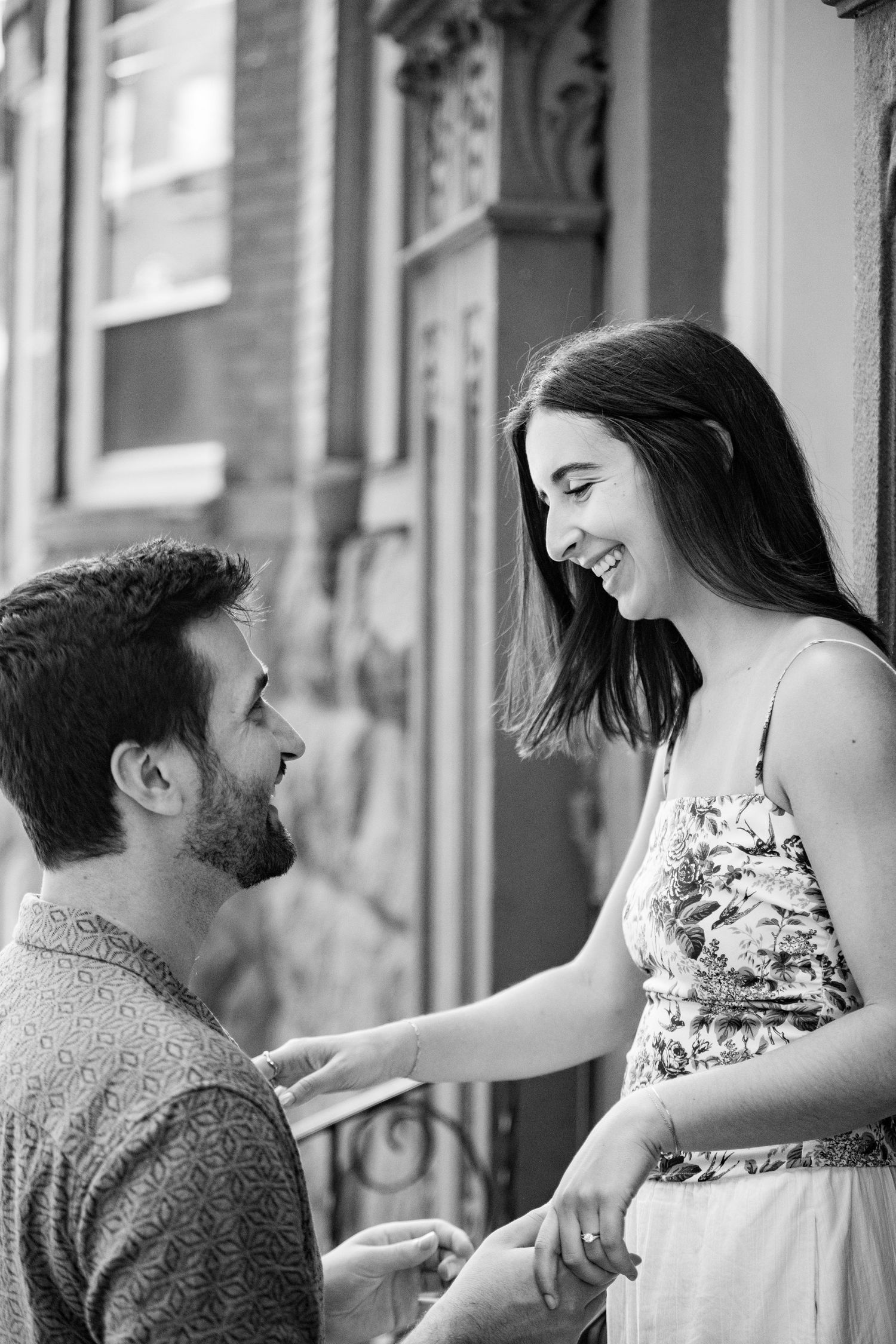 Black and white photo collage showing romantic couple having playful interaction at a balcony.